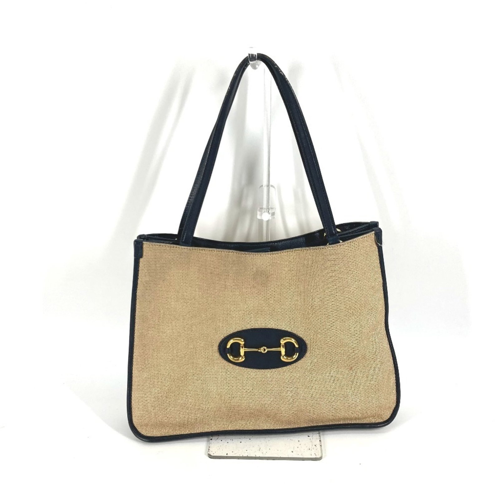 Canvas Leather Gucci Bag Tote Shoulder: Canvas Leather Gucci Bag Tote Shoulder Canvas Leather Gucci Bag Tote Shoulder - A pre-owned, beige and navy canvas leather tote bag with shoulder strap from the iconic Gucci brand. The bag features a