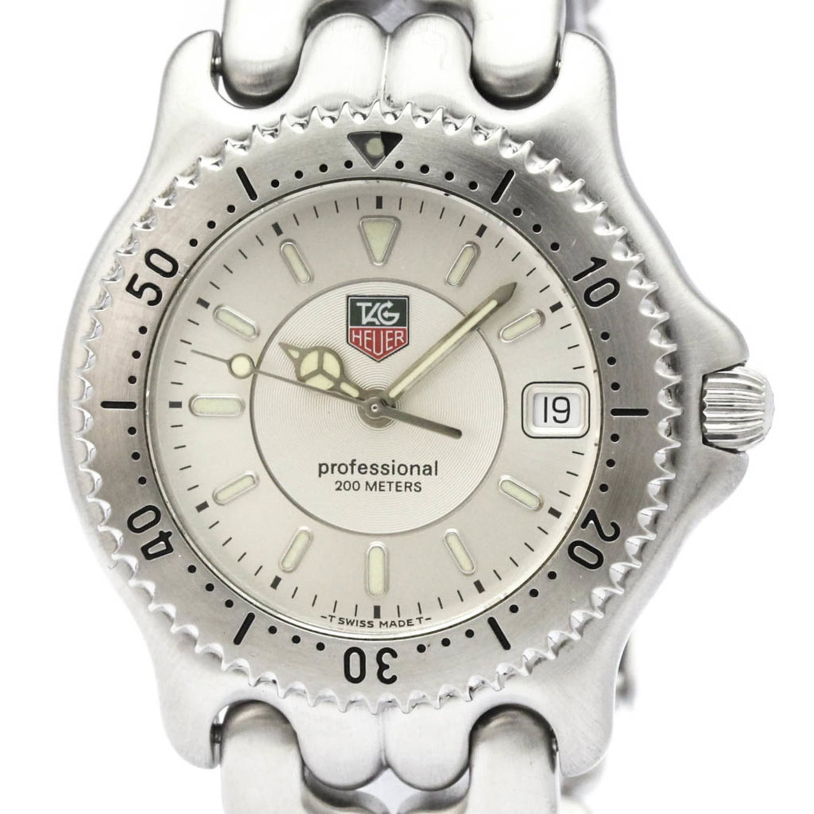Wristwatch by Heuer: Wristwatch by Heuer Stainless steel case and band add durability to this silver dial watch, measuring 38mm in diameter. A few traces of usage can be seen on the case, with some minor scratches and dir