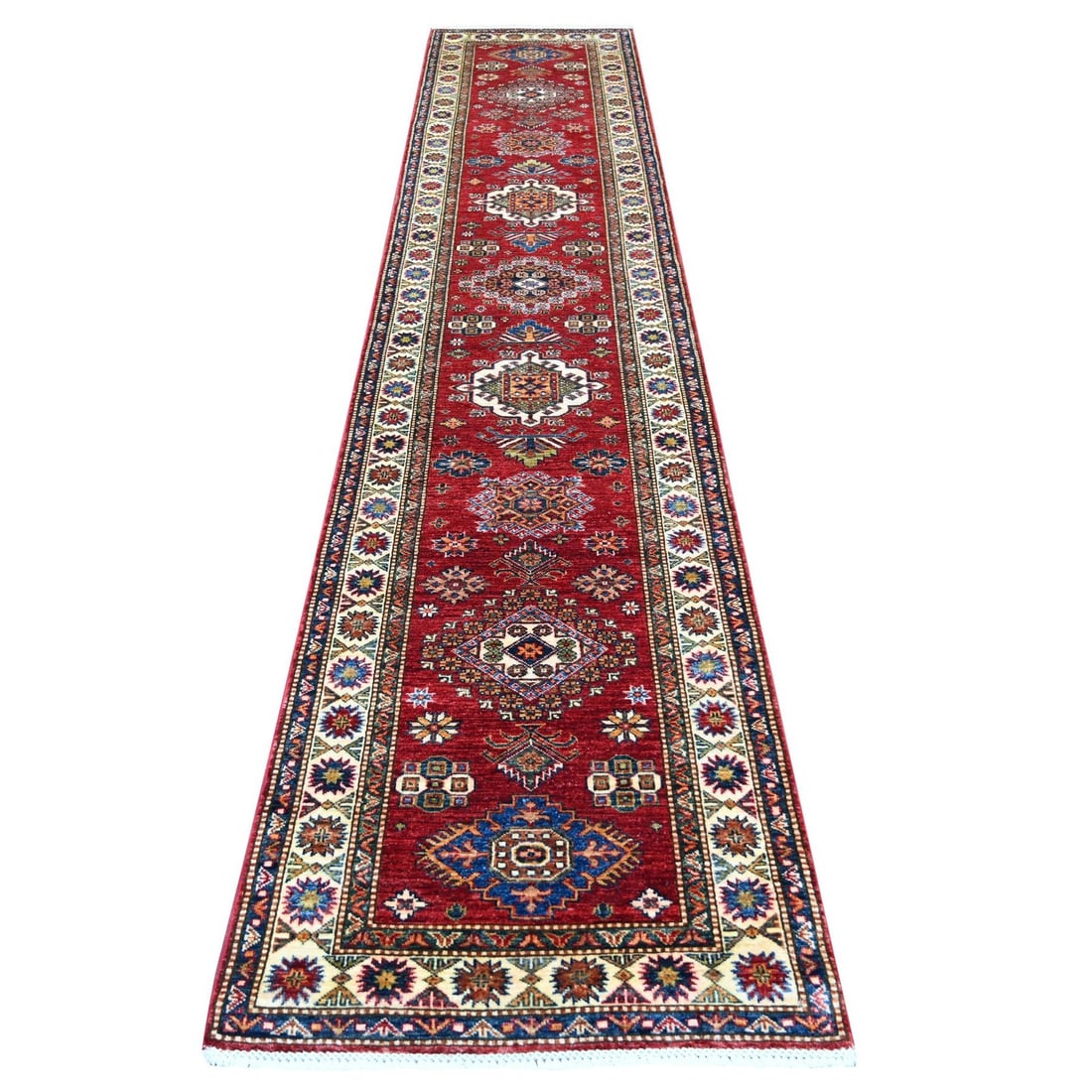 2'7"x13' Red Afghan Super Kazak Hand Knotted Pure Wool Runner Rug: 2'7"x13' Red Afghan Super Kazak Hand Knotted Pure Wool Runner Rug Red Afghan Super Kazak Hand Knotted Pure Wool Runner Rug, measuring 2'7" x 13', boasts an all-over regional design in a vibrant red