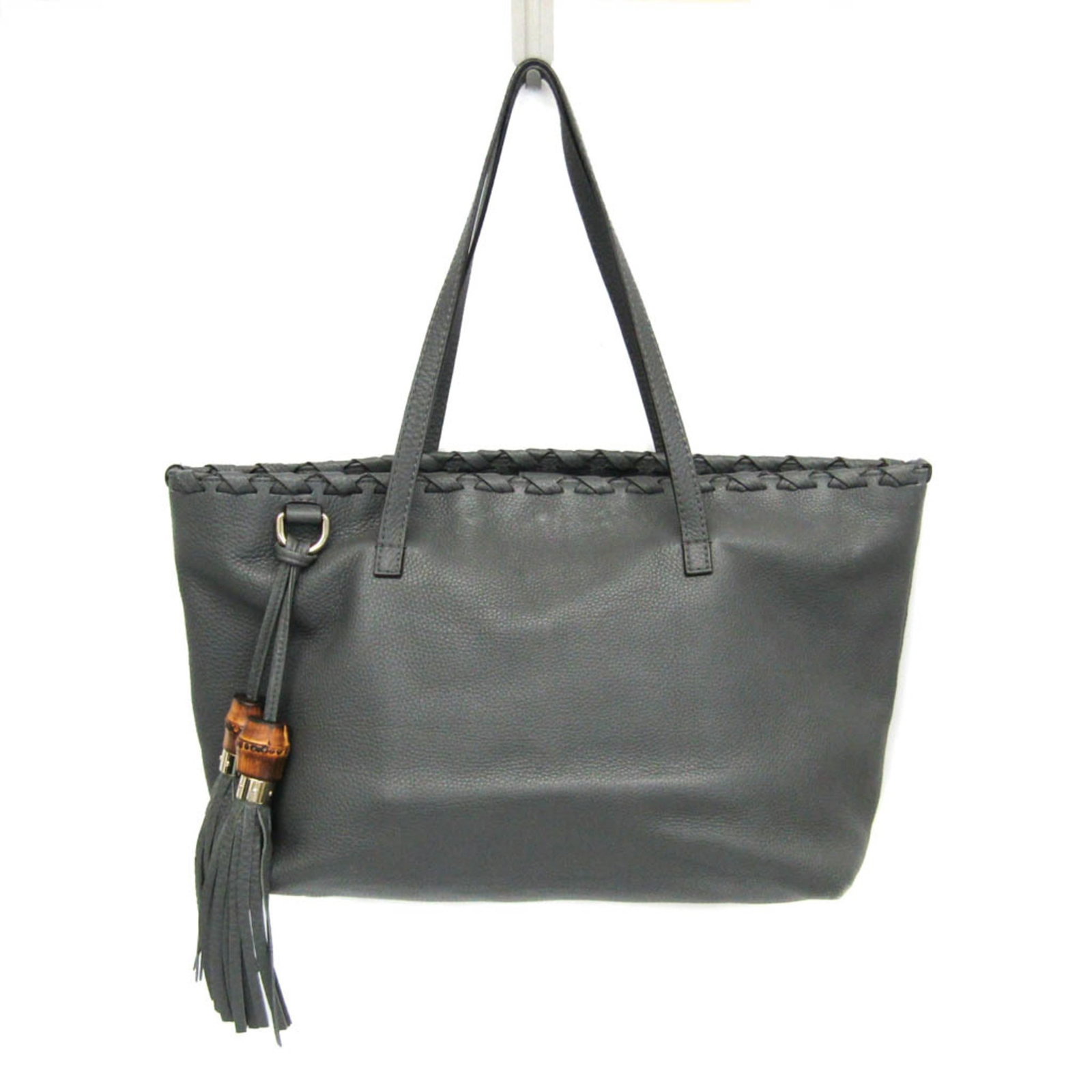 Tote bag leather by Gucci: Tote bag leather by Gucci Gray Gucci leather tote bag with champagne gold hardware, featuring magnetic snap closure and interior zipper pocket. The bag boasts a classic design with one open pocket