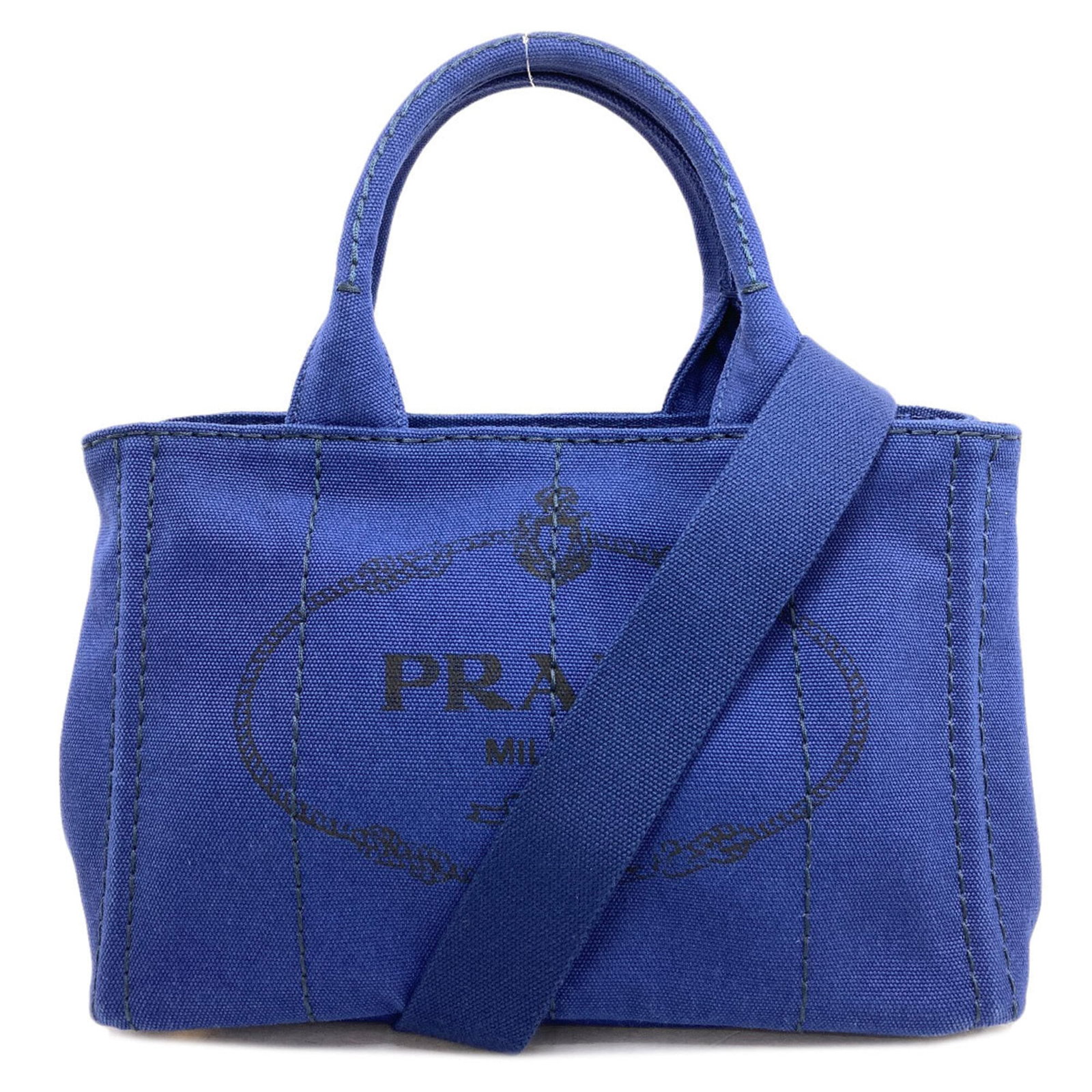 Handbag Canvas By Prada: Handbag Canvas By Prada Canvas by Prada, a blue handbag with a canvas material and dimensions of 18cm x 28cm x 16cm. This used item shows traces of usage, including scratches and dirt, but remains in