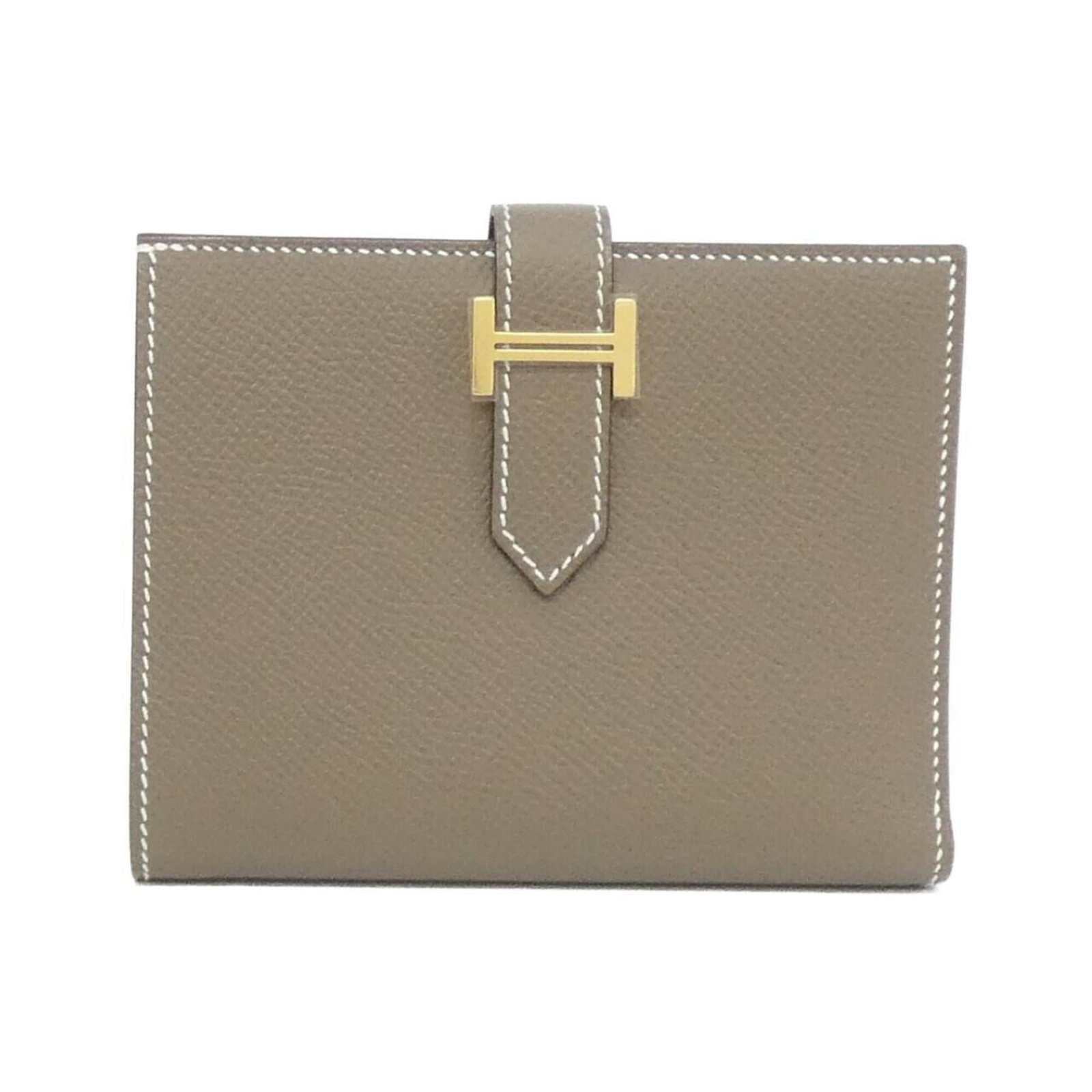 Epsom Leather Bi Fold Hermes Wallet: Epsom Leather Bi Fold Hermes Wallet Epsom Leather Bi Fold Wallet from Hermes, featuring a timeless design with subtle scratches and signs of wear. This bi-fold wallet boasts classic Epsom leather