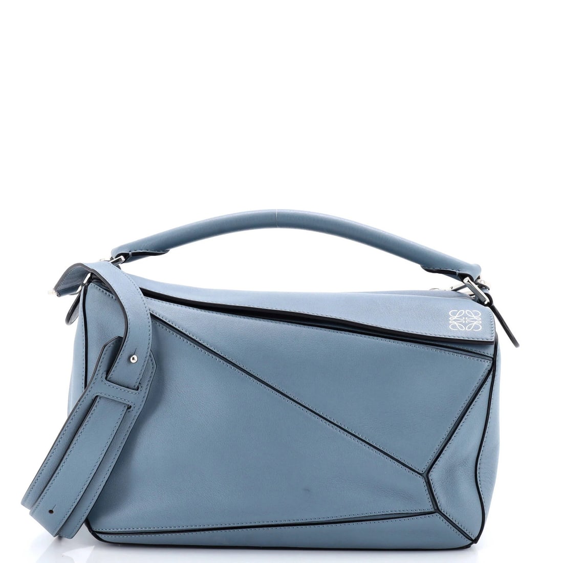 Puzzle bag leather medium Loewe: Puzzle bag leather medium Loewe The Puzzle Bag Leather Medium from Loewe boasts a striking blue exterior and neutral interior, perfectly balanced by silver hardware. Measuring 6.5" tall and 11" wide,