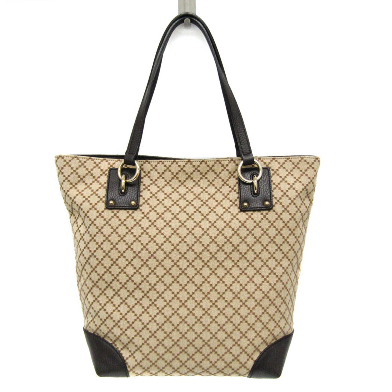 Canvas leather bag tote gucci: Canvas leather bag tote gucci Canvas leather bag tote from Gucci, featuring a beige and brown color combination. This used tote bag has some traces of usage, with visible scratches and dirt, but