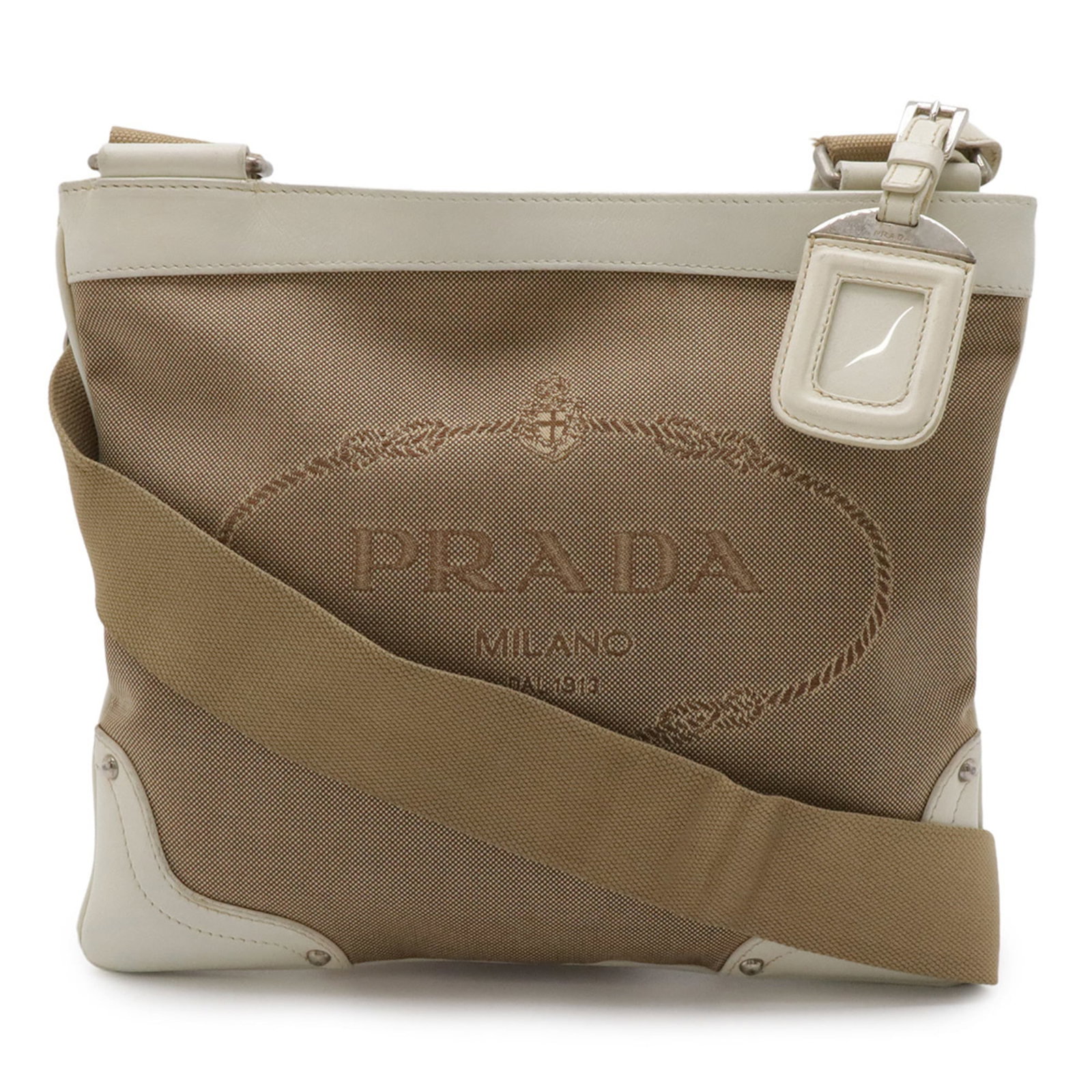 Shoulder Bag Canvas Pochette Prada: Shoulder Bag Canvas Pochette Prada Canvas Pochette in Beige, Ivory. This Prada shoulder bag features canvas material and measures 23cm x 26cm. Used condition with traces of usage, scratches / dirt