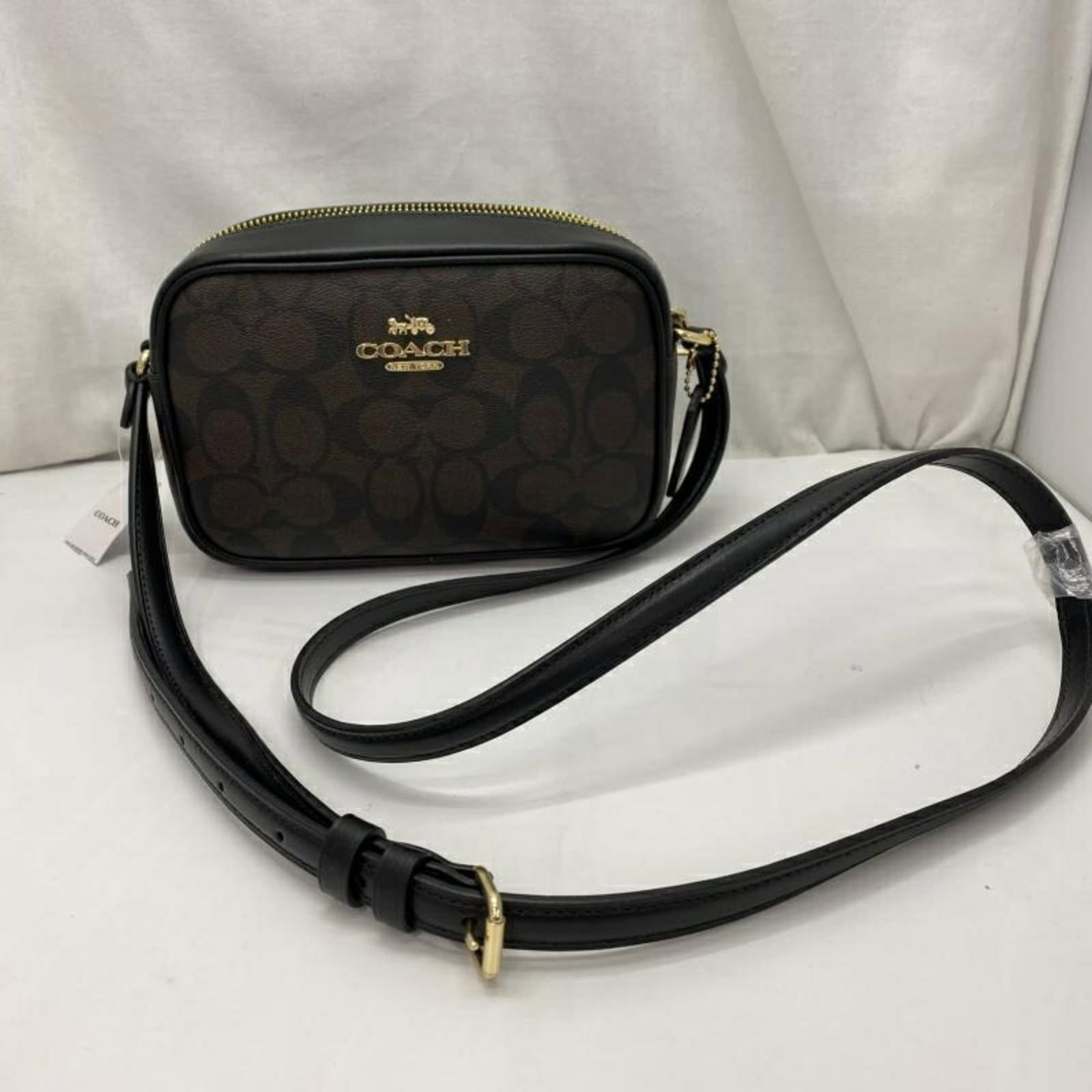 Shoulder Bag by Coach: Shoulder Bag by Coach Brown Coach shoulder bag with a classic design, featuring a sturdy build and comfortable strap length. The bag has some minor scratches and dirt from previous use, but remains
