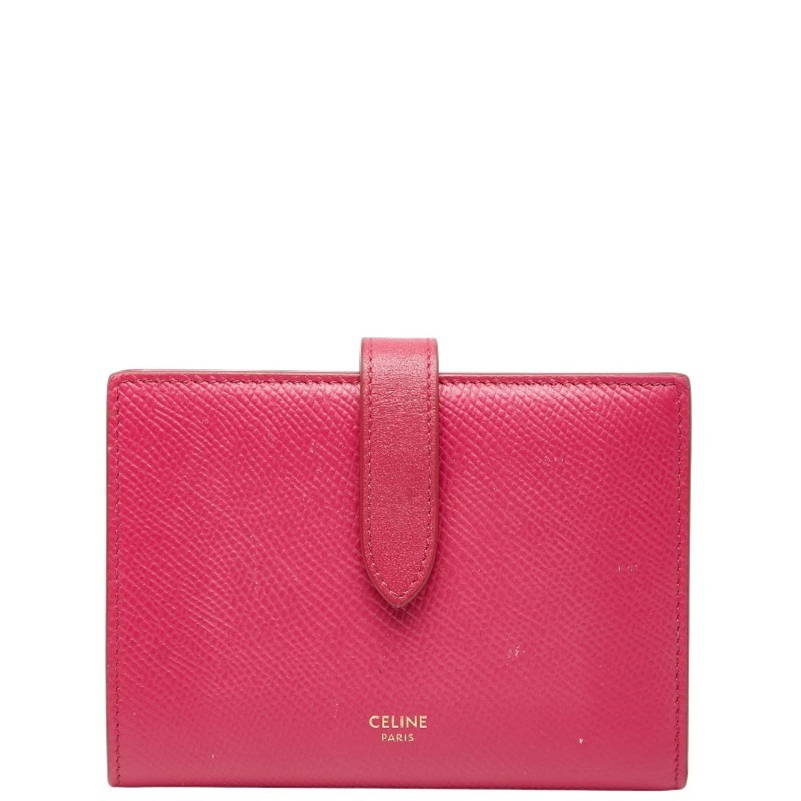 Celine wallet bi fold leather: Celine wallet bi fold leather Pink Celine bi-fold leather wallet with a classic design, featuring a subtle pink color and a durable leather material. The wallet has some traces of usage, scratches,
