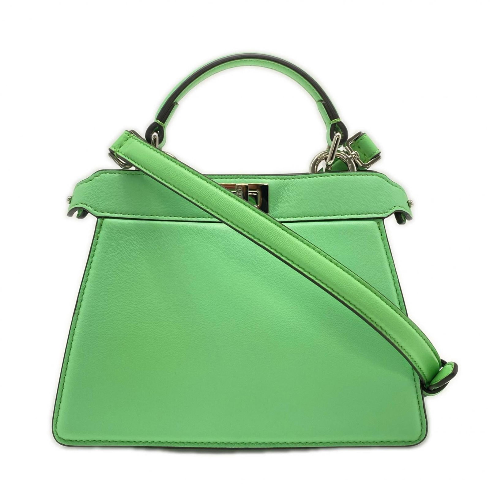 Handbag Leather by Fendi: Handbag Leather by Fendi Fendi's iconic handbag boasts a rich green calfskin exterior, adorned with a sturdy turn lock closure and open pocket for added convenience. Measuring 15.5cm x 20cm x 11cm,
