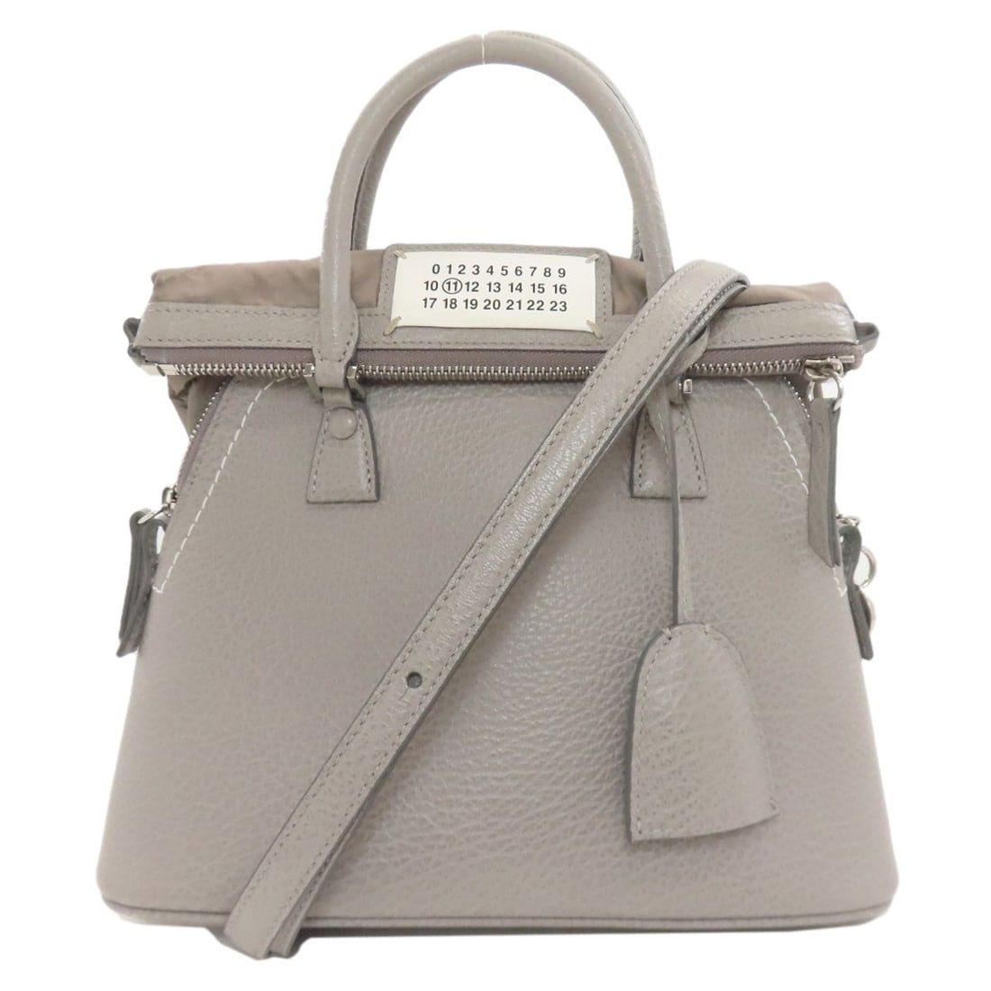 Maisonmargiela 5Ac 2Way Handbag Calf: Maisonmargiela 5Ac 2Way Handbag Calf The MaisonMargiela 5Ac 2Way Handbag Calf boasts a sleek, gray exterior crafted from high-quality calf leather. This stylish handbag features a distinctive design
