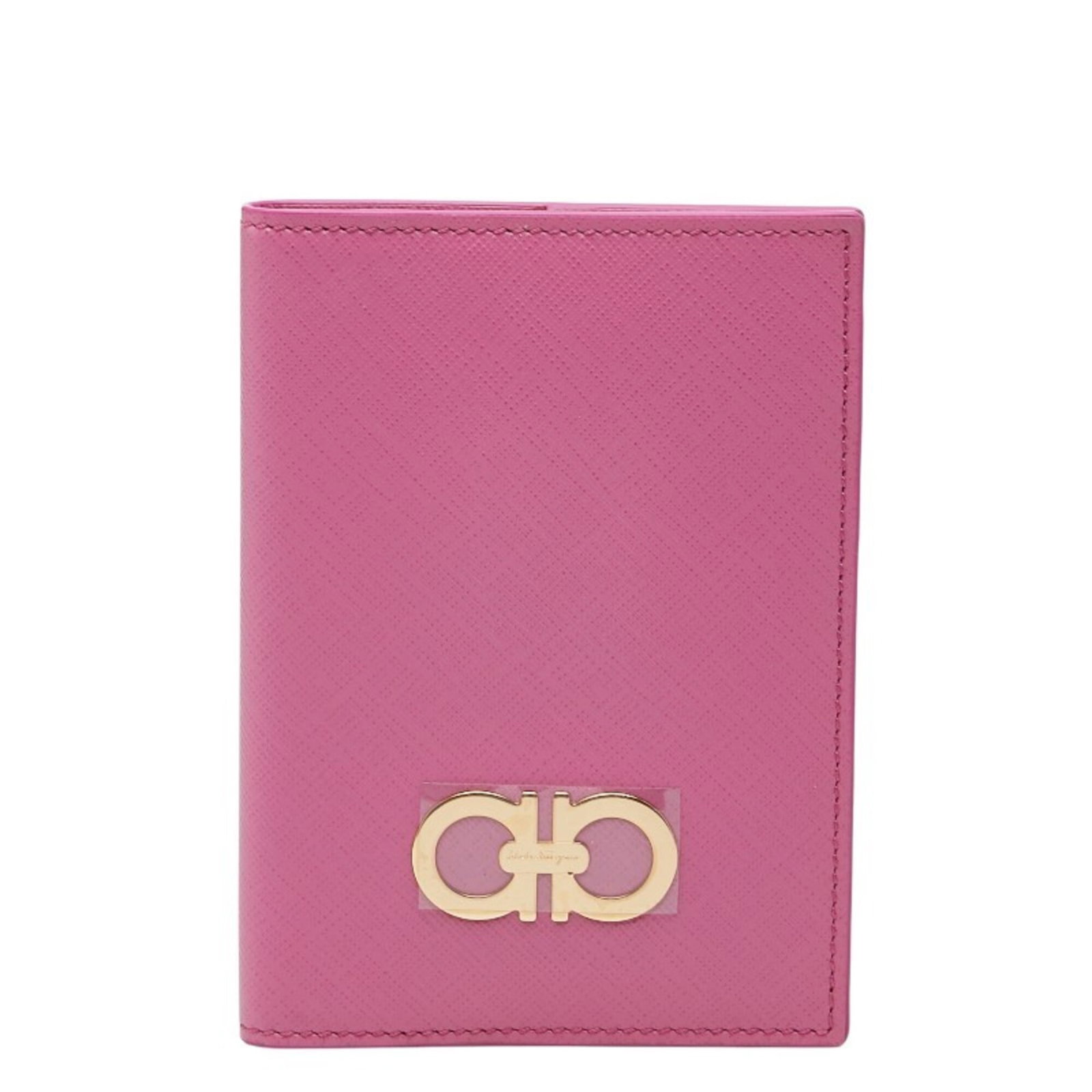 Passport leather cover by Salvatore Ferragamo: Passport leather cover by Salvatore Ferragamo Pink leather passport cover by Salvatore Ferragamo, featuring a subtle design and premium material. The cover shows some signs of usage, including minor