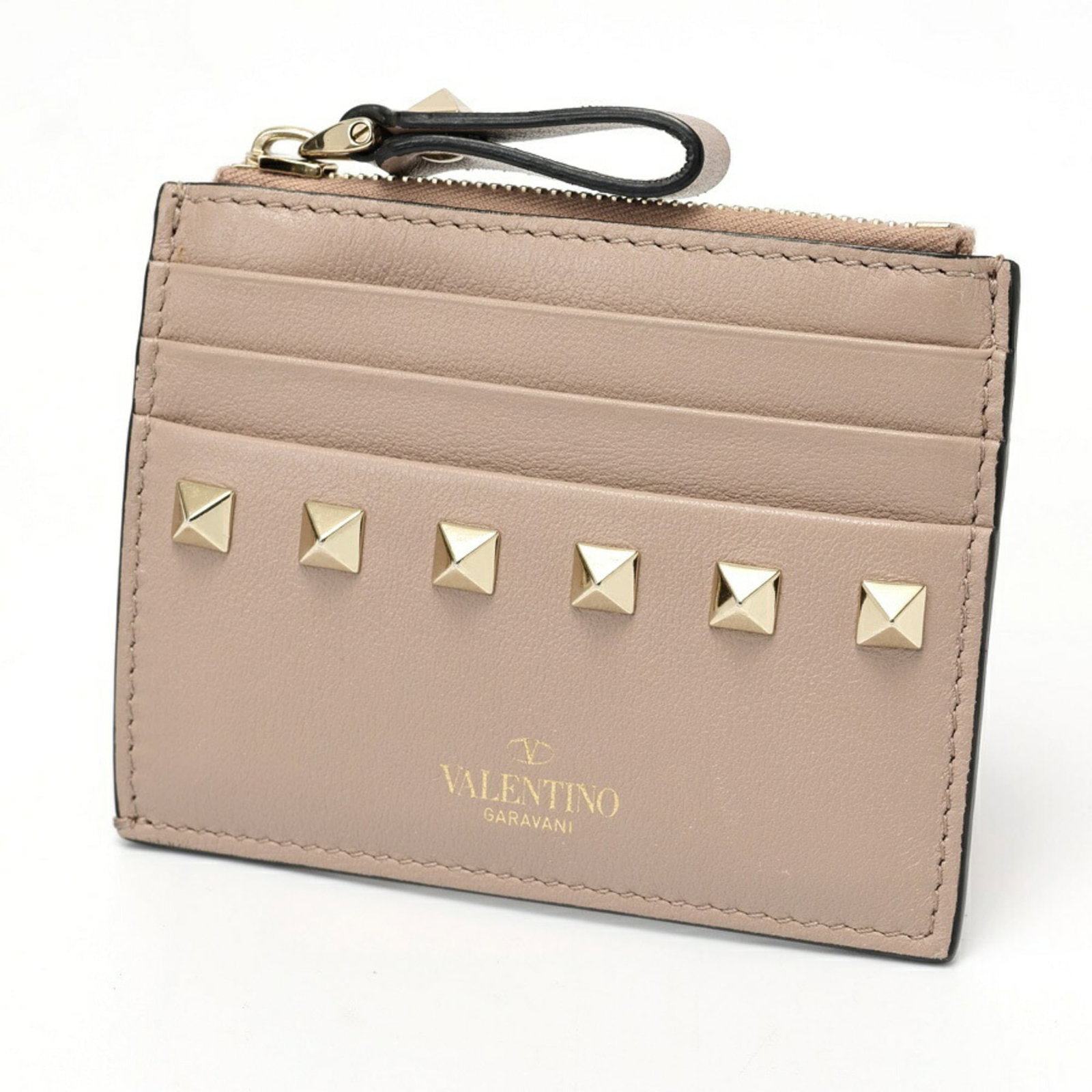 Valentino Coin Purse/ Coin Case Leather: Valentino Coin Purse/ Coin Case Leather Valentino's iconic coin purse features a soft pink beige leather exterior, adding a touch of elegance to any outfit. Measuring 8.5cm x 10.5cm, this compact case