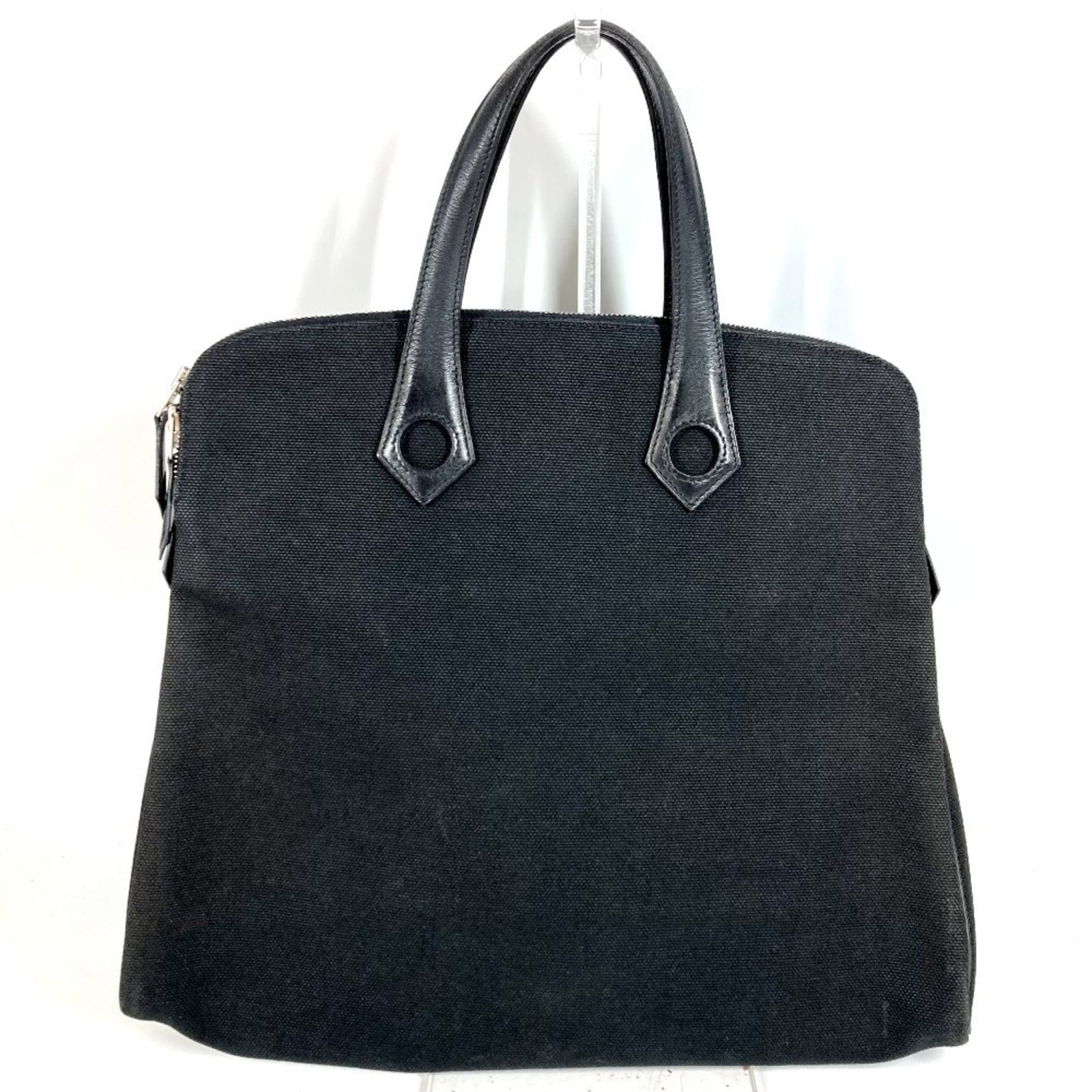 Handbag Tote Briefcase Leather Canvas Hermes: Handbag Tote Briefcase Leather Canvas Hermes Black leather and canvas briefcase with classic Hermes design, measuring 32cm x 38.5cm x 5.5cm. This used tote bag features a durable construction with