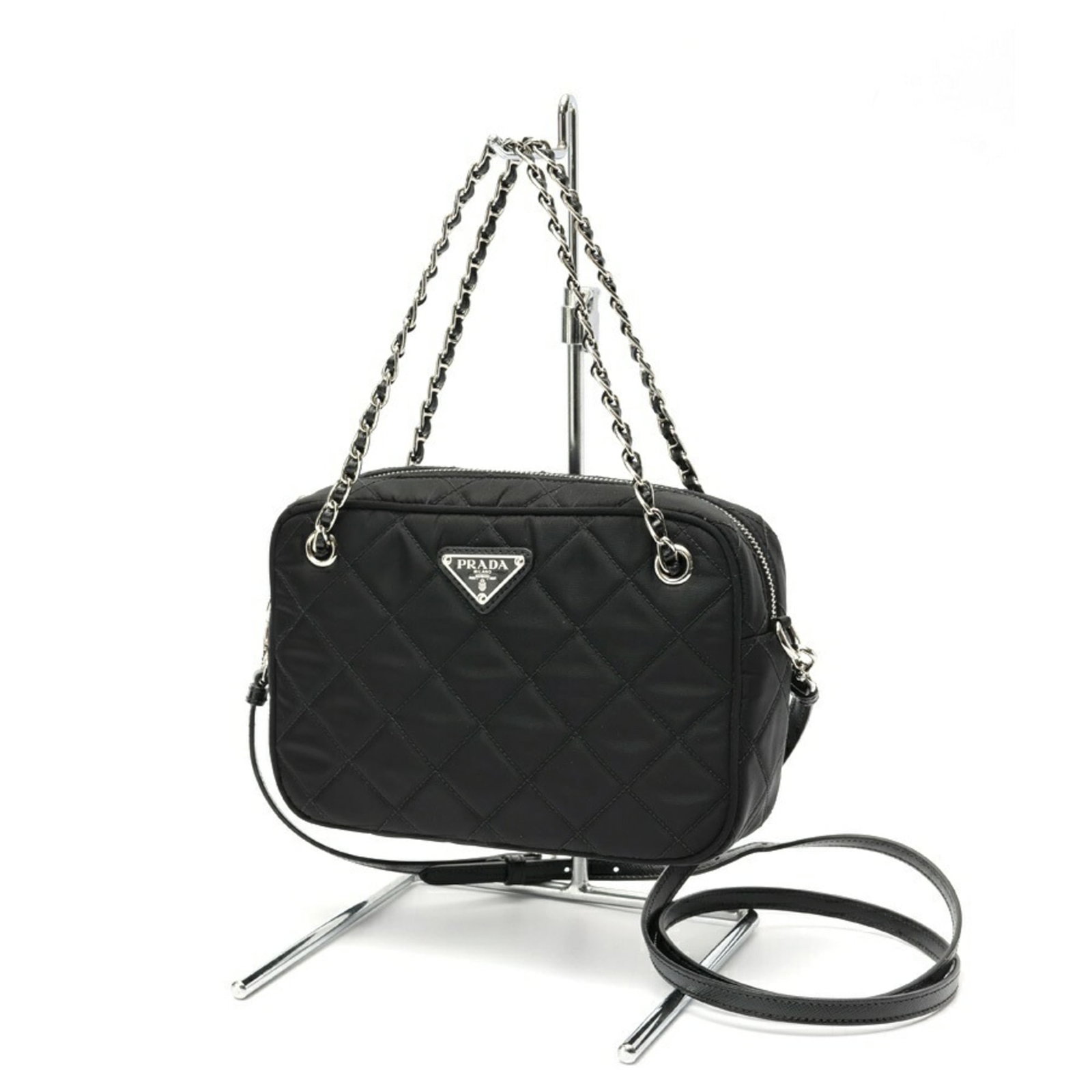 Nylon Shoulder Bag by Prada: Nylon Shoulder Bag by Prada Prada's Nylon Shoulder Bag is a versatile and stylish accessory, featuring a sleek black design made from durable nylon material. Measuring 14cm x 21cm x 6cm, it has a