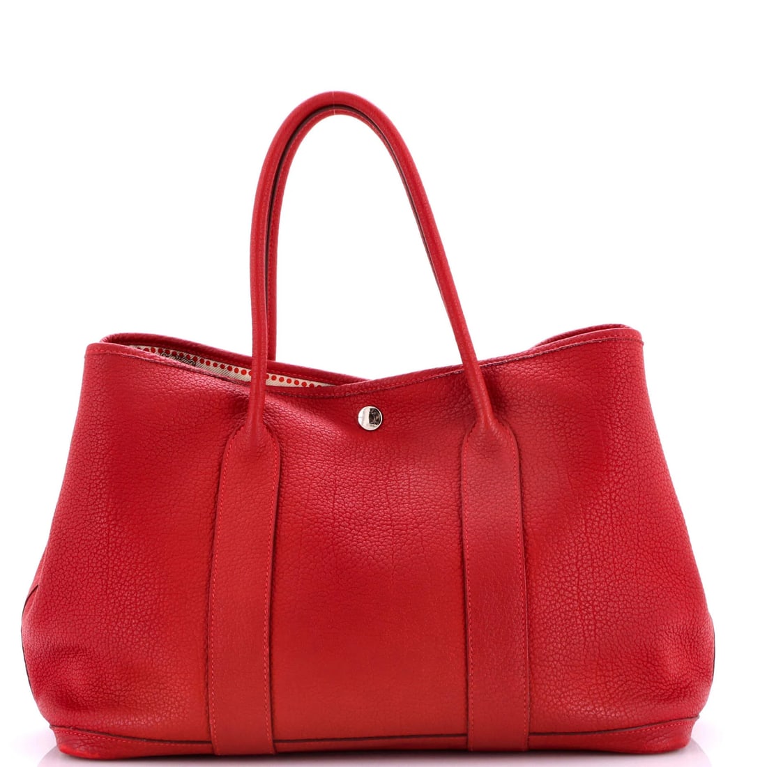 Tote Leather Hermes with 36 Party Garden Printed Interior: Tote Leather Hermes with 36 Party Garden Printed Interior Red leather tote from Hermes with a striking 36 Party Garden printed interior. The exterior features heavy corner wear, edge wear, and