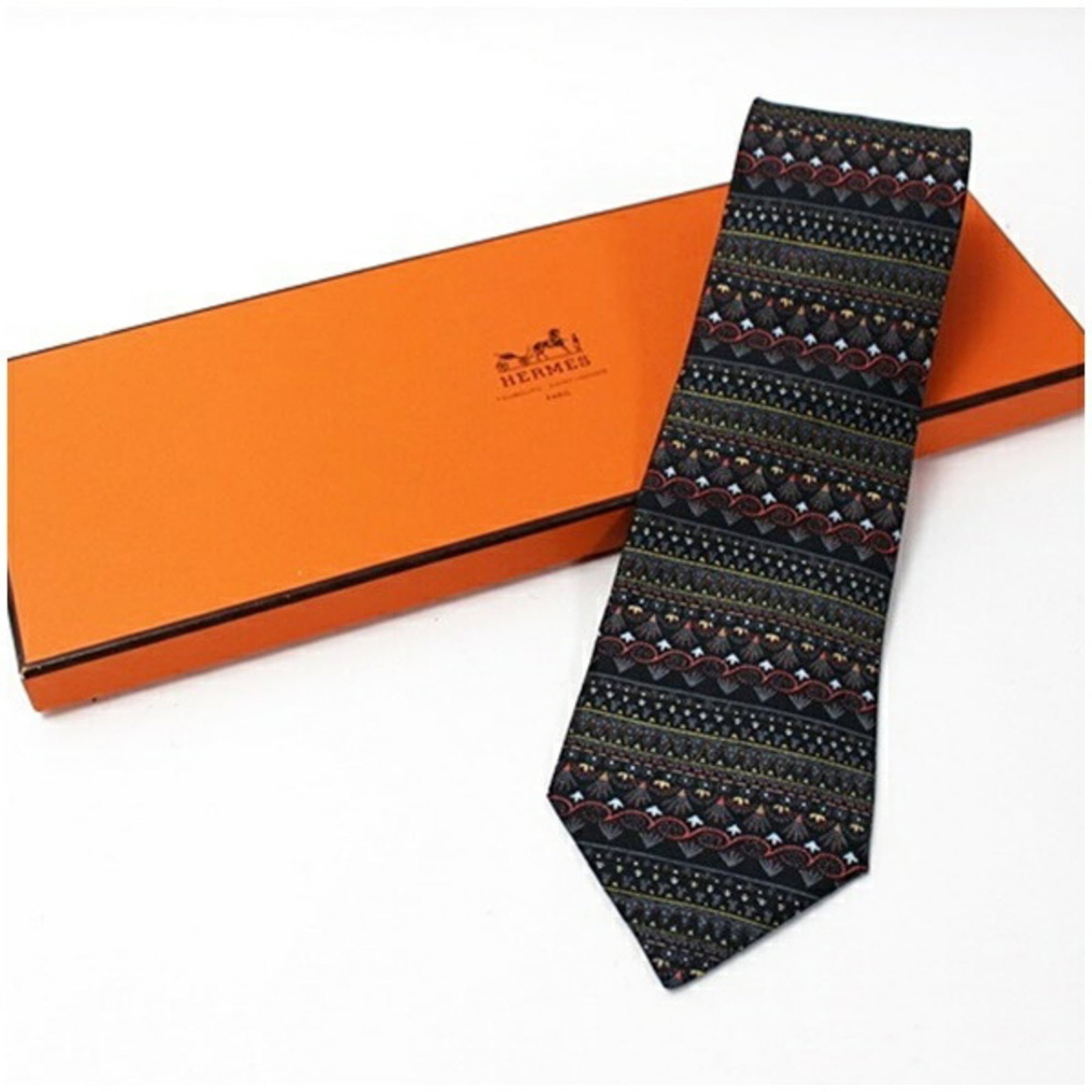Cravat Silk by Hermes: Cravat Silk by Hermes Silk cravat from renowned French fashion house Hermes, featuring a black and multi-color design. The item boasts a 9cm width and is made from high-quality silk material. With