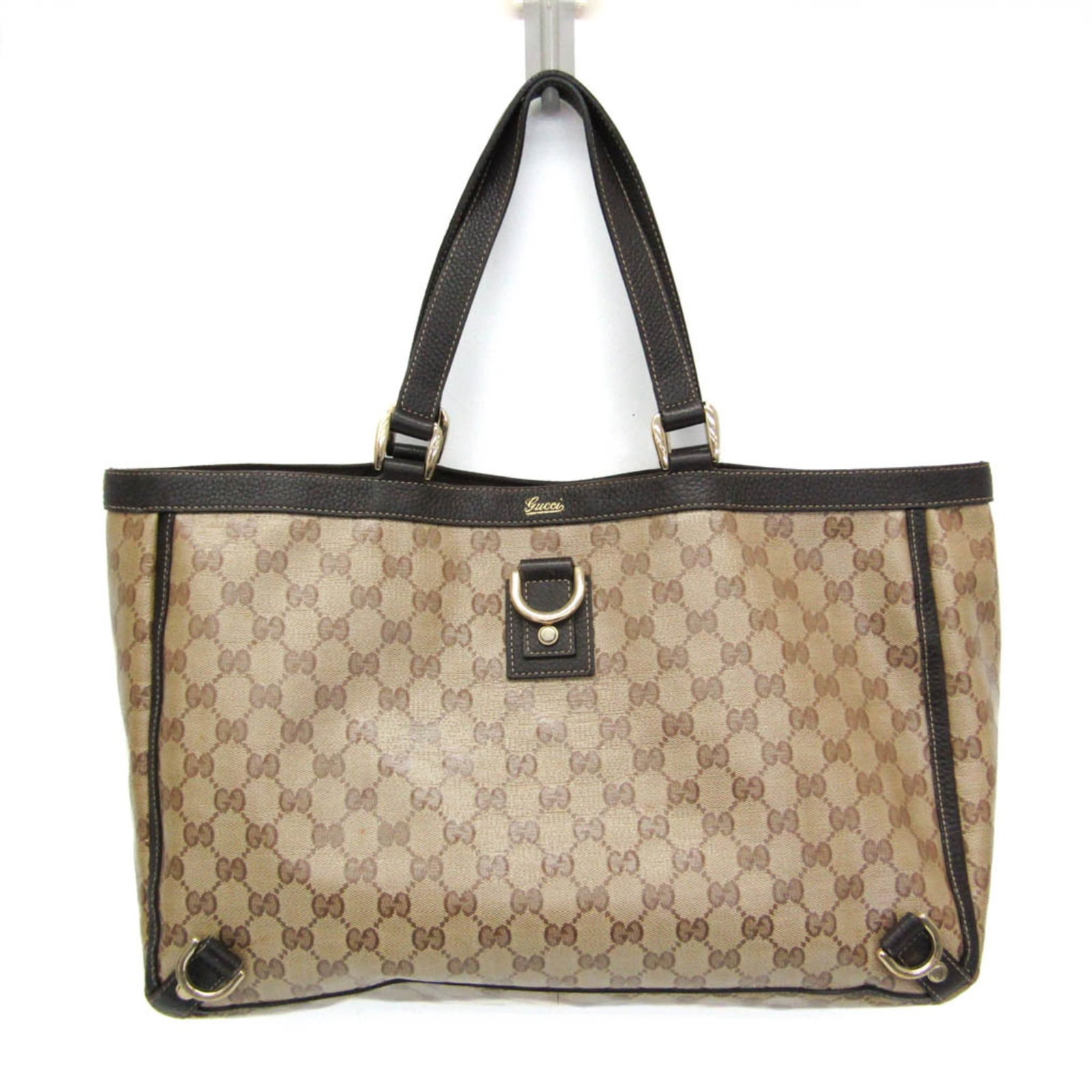 Crystal leather tote bag by Gucci: Crystal leather tote bag by Gucci Crystal leather tote bag by Gucci in beige and brown hues, featuring a magnetic snap closure and zipper pocket for added functionality. The Gg Crystal material adds