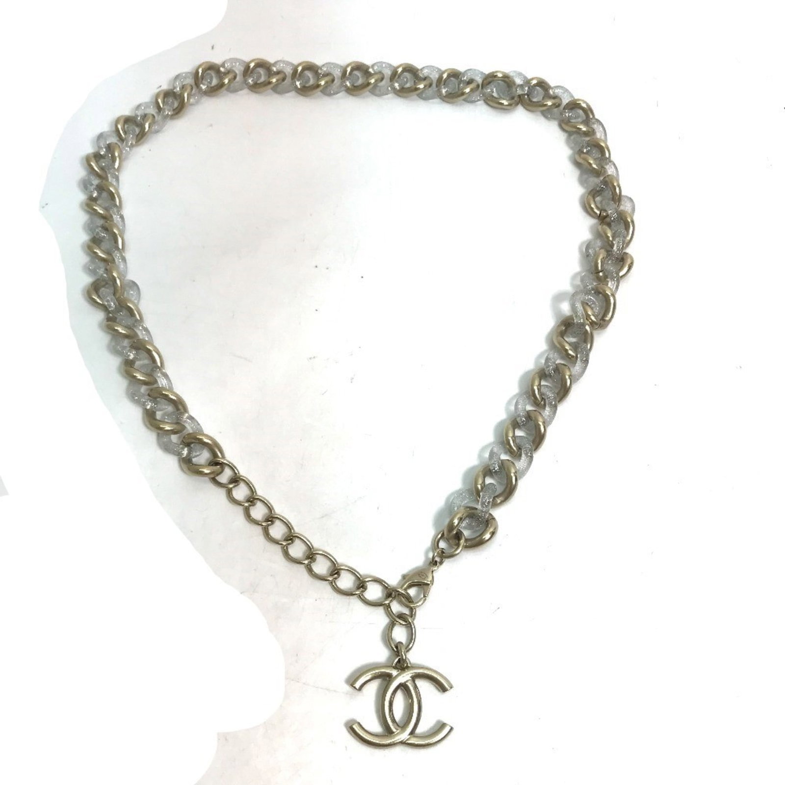 Chain Belt by Chanel: Chain Belt by Chanel Chain Belt by Chanel, a gold chain belt with metal and plastic details, measures 88cm in length. The item bears traces of usage and has minor scratches/dirt, but remains in good