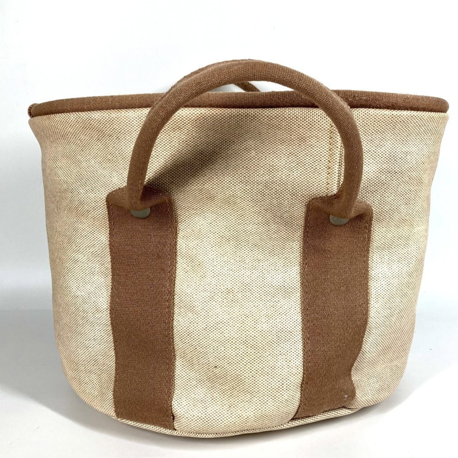 Coated Canvas by Hermes Basket Handbag: Coated Canvas by Hermes Basket Handbag Coated canvas construction provides durability and style, while the classic basket design from Herm?s offers timeless elegance. This beige handbag features