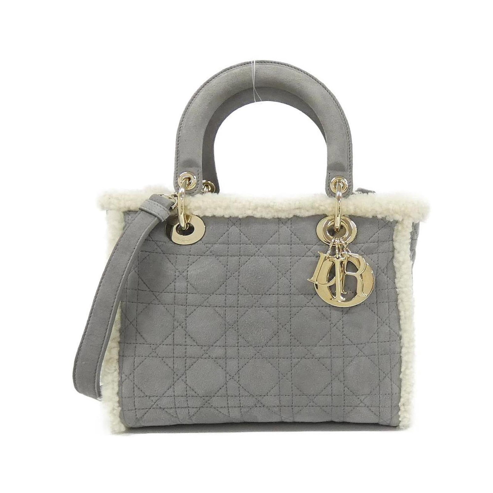 Suede Handbag Dior Christian: Suede Handbag Dior Christian Suede Dior Christian handbag in gray, featuring gold hardware. This pre-owned bag has a few traces of usage and some scratches/dirt, but remains in very good condition.