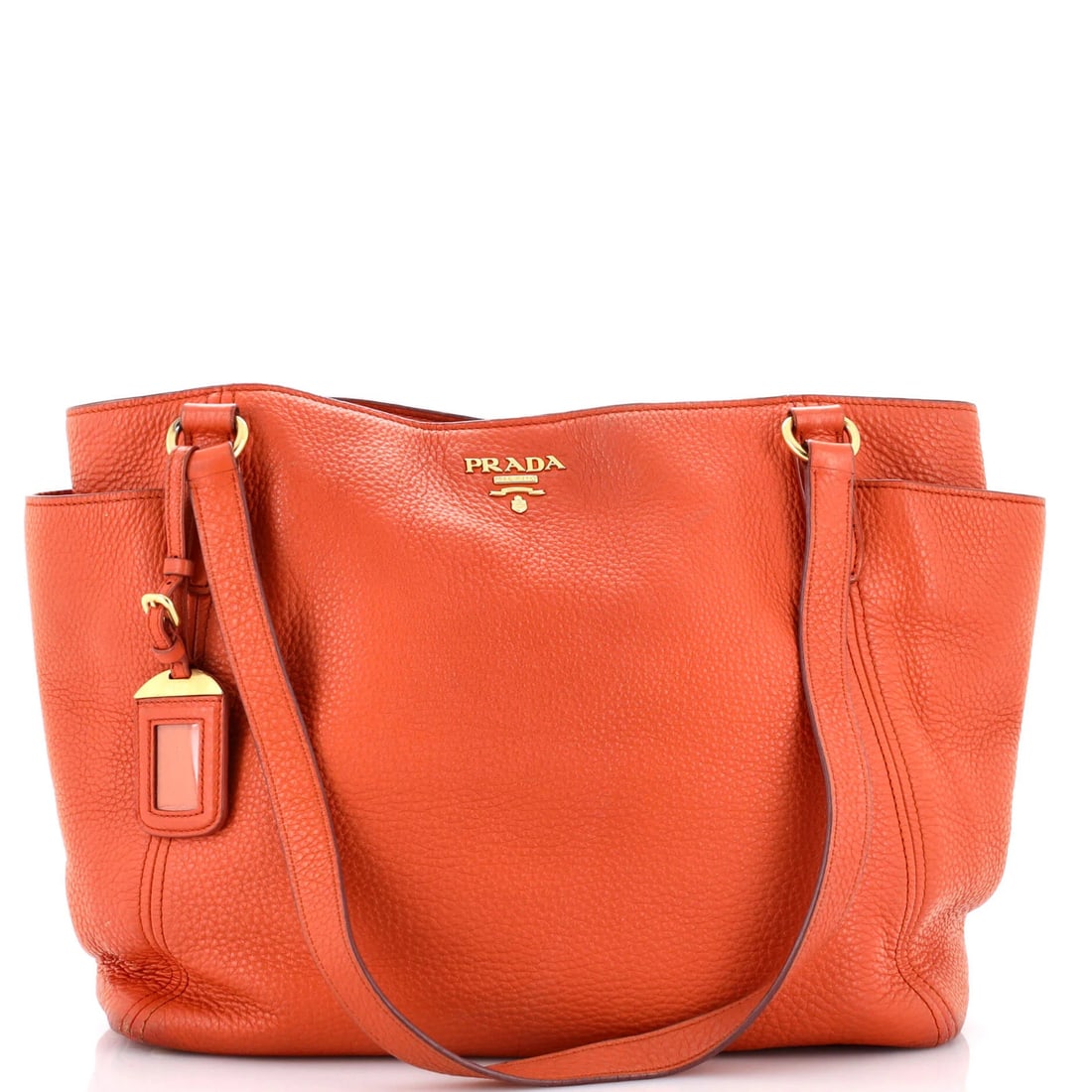 Side Pocket Convertible Large Tote Vitello Daino Prada: Side Pocket Convertible Large Tote Vitello Daino Prada This Side Pocket Convertible Large Tote Vitello Daino Prada features a vibrant orange exterior with heavy corner wear and edge wear, showcasing i
