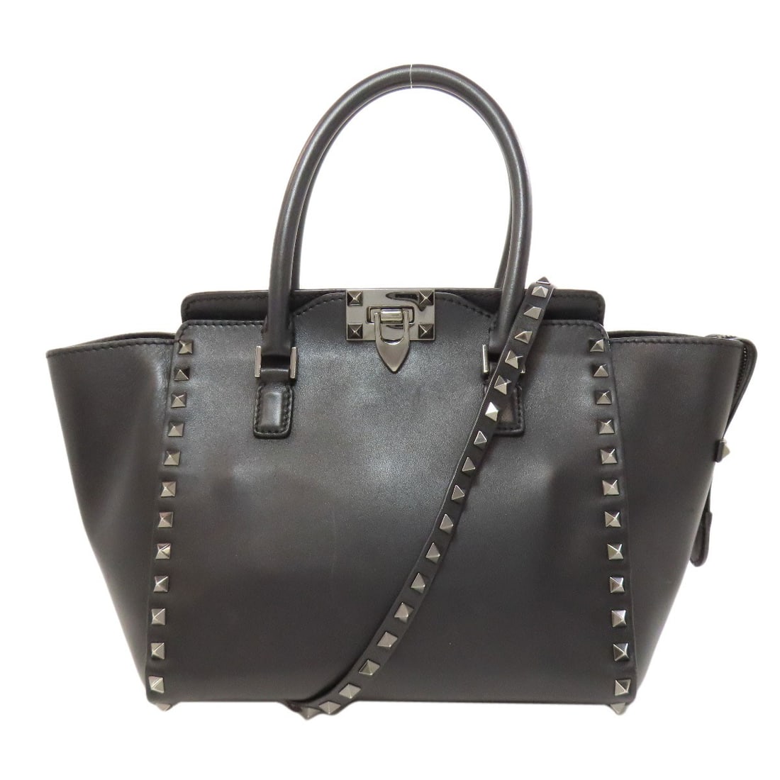 Valentino Studs 2Way Handbag Leather: Valentino Studs 2Way Handbag Leather Black leather handbag with Valentino studs, designed for a modern and sophisticated look. The 2-way design adds versatility to the classic style, making it