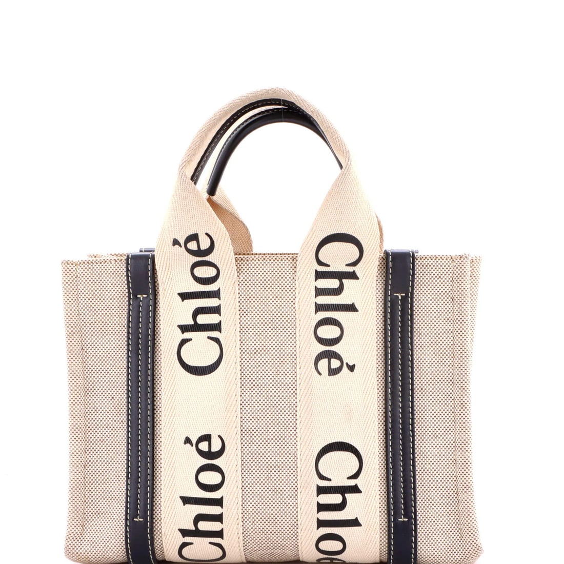 Canvas tote with leather small from Chloe Woody: Canvas tote with leather small from Chloe Woody Canvas tote with leather small from Chloe Woody, featuring neutral exterior and interior colors, and a classic design. The bag boasts a sturdy canvas co