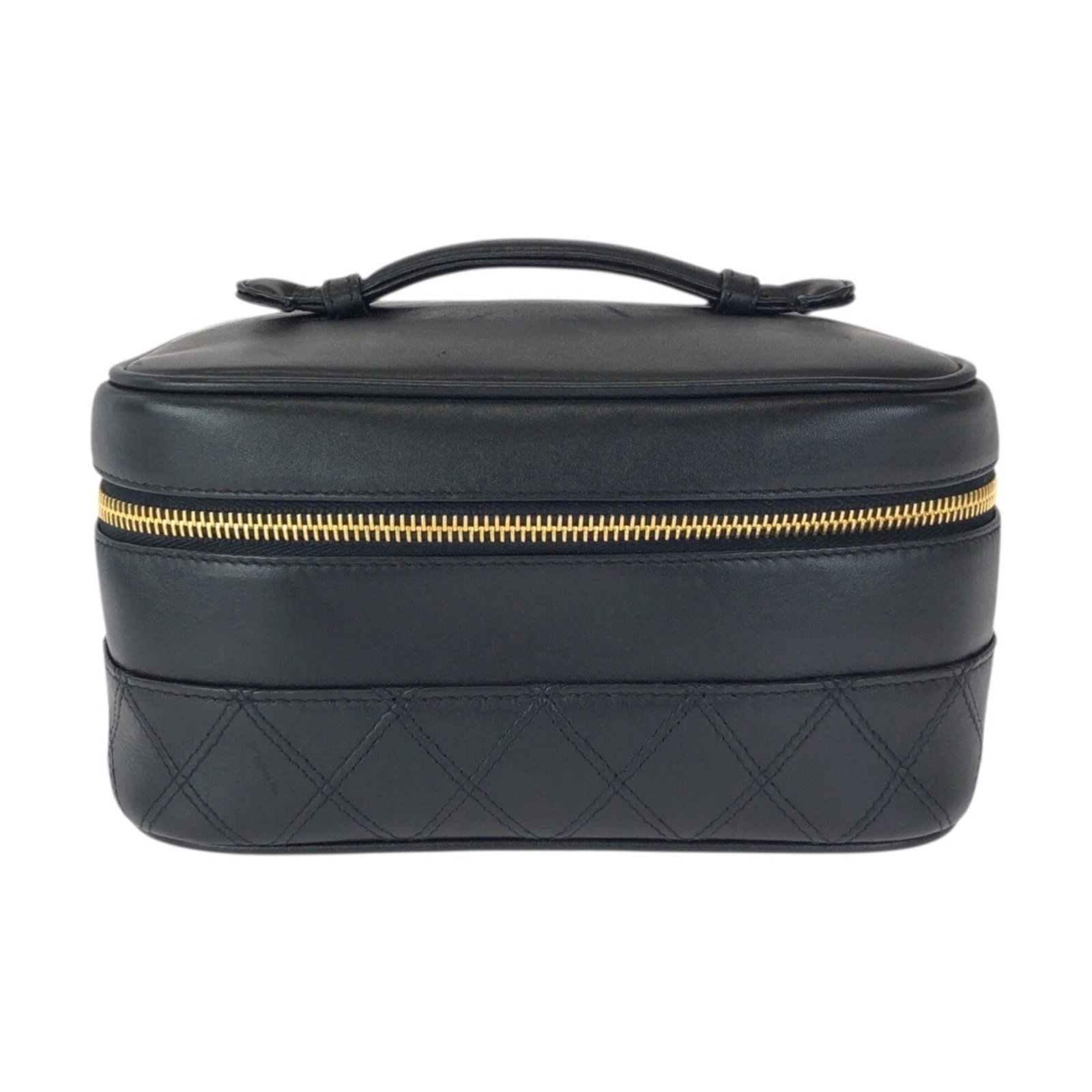 Vanity bag leather pouch by Chanel: Vanity bag leather pouch by Chanel Chanel's iconic lambskin vanity bag features sleek black leather with subtle signs of wear, adding to its timeless charm. The compact size and classic design make