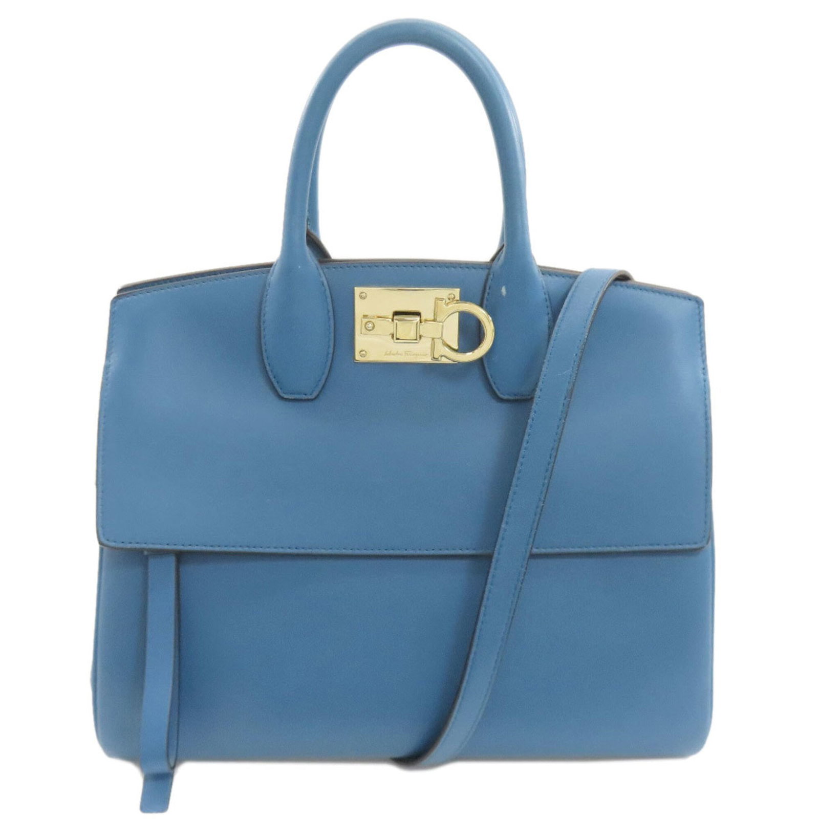 Handbag Leather by Salvatore Ferragamo: Handbag Leather by Salvatore Ferragamo Blue leather handbag by Salvatore Ferragamo, featuring a classic design with a 22cm handle and adjustable strap length. The bag has traces of usage, scratches, a