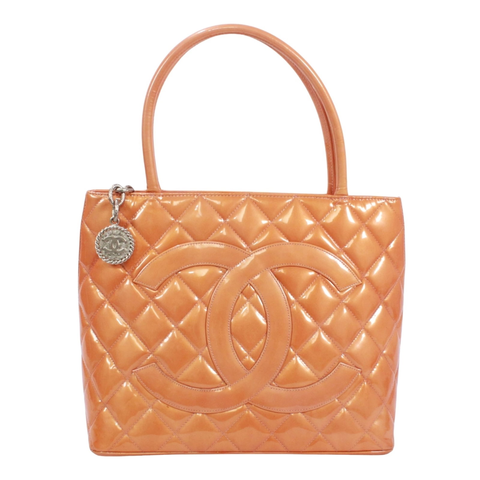 Tote Bag Patent Leather by Chanel: Tote Bag Patent Leather by Chanel Patent leather tote bag by Chanel, featuring a vibrant orange color and a classic design. Made from high-quality patent leather, this tote bag has a distinctive sheen