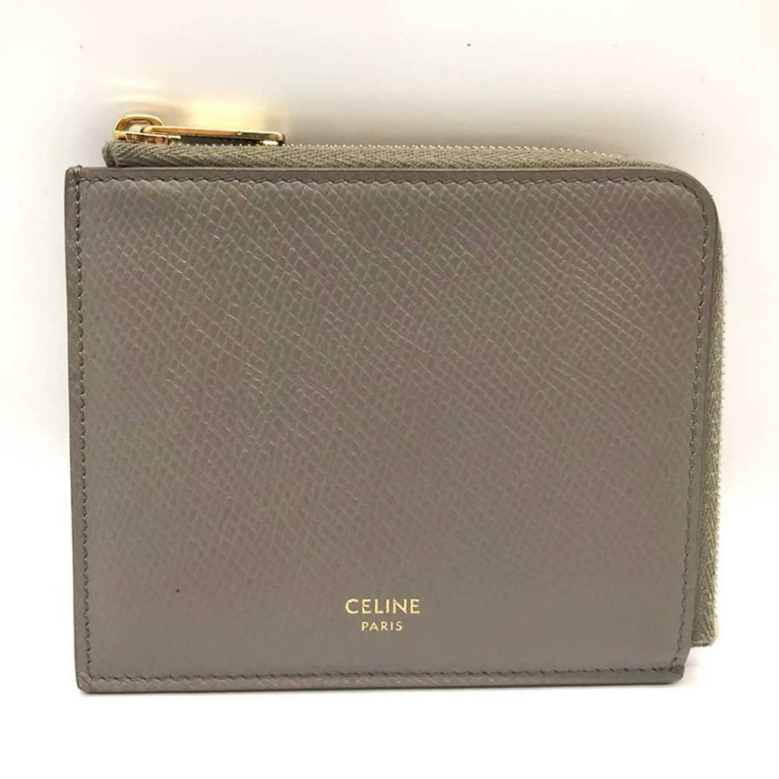 Business card case by Celine: Business card case by Celine Gray Celine business card case with traces of usage and minor scratches, bearing the brand's signature. Made from high-quality materials, this compact case features a