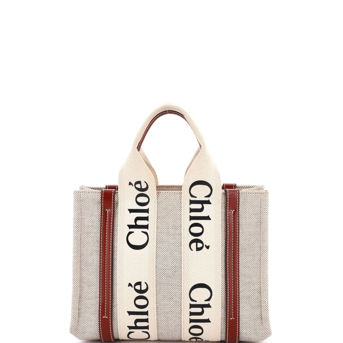 Canvas tote small with leather from chloe woody: Canvas tote small with leather from chloe woody Small canvas tote with leather details from Chloe's Woody collection, featuring neutral exterior and interior colors. The item boasts a classic design w