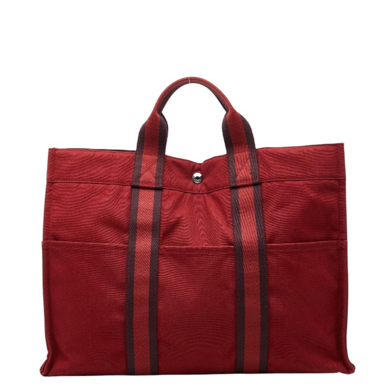 Canvas tote bag by Hermes: Canvas tote bag by Hermes Canvas tote bag by Hermes, featuring a striking red color and a classic design. The bag's canvas material and timeless style make it a versatile accessory for everyday use.