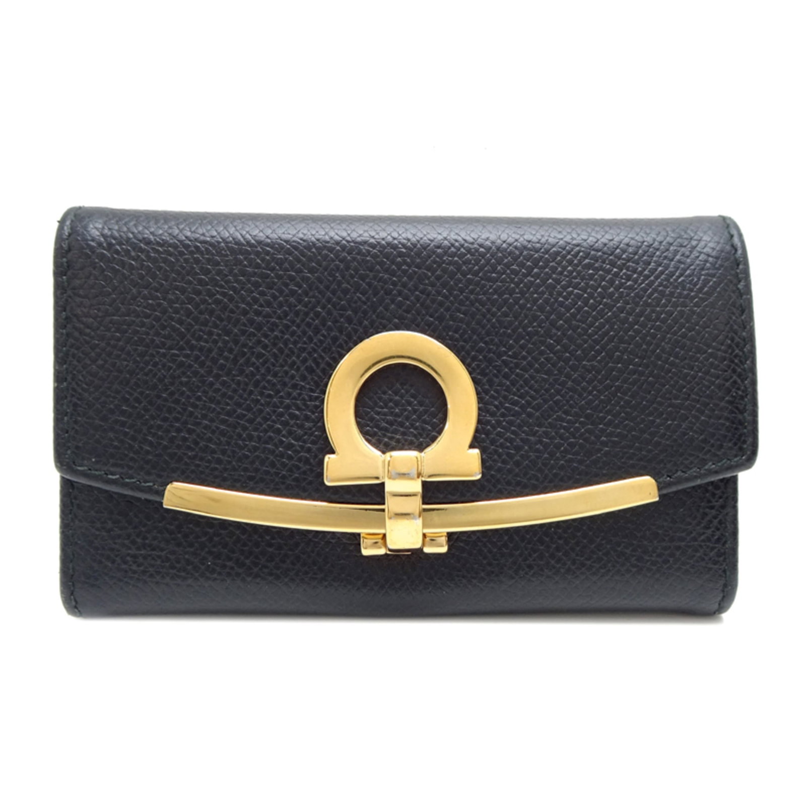 Salvatore Ferragamo Leather Keycase: Salvatore Ferragamo Leather Keycase This Salvatore Ferragamo Leather Keycase boasts sleek black leather and bears the signature of the renowned brand. With traces of usage visible, it showcases a