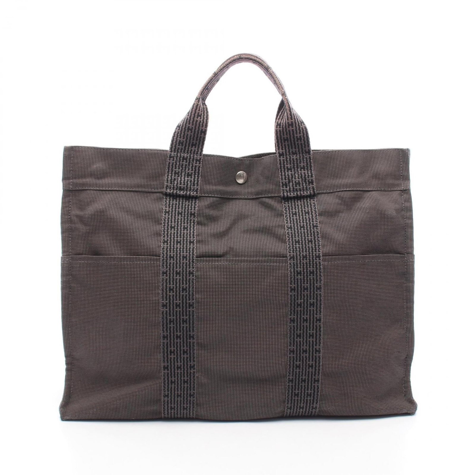 Nylon canvas tote bag by Hermes: Nylon canvas tote bag by Hermes Nylon canvas tote bag by Hermes, featuring a durable and versatile design. This used (good) tote bag boasts a gray color and measures 32cm x 42cm x 11cm. With traces