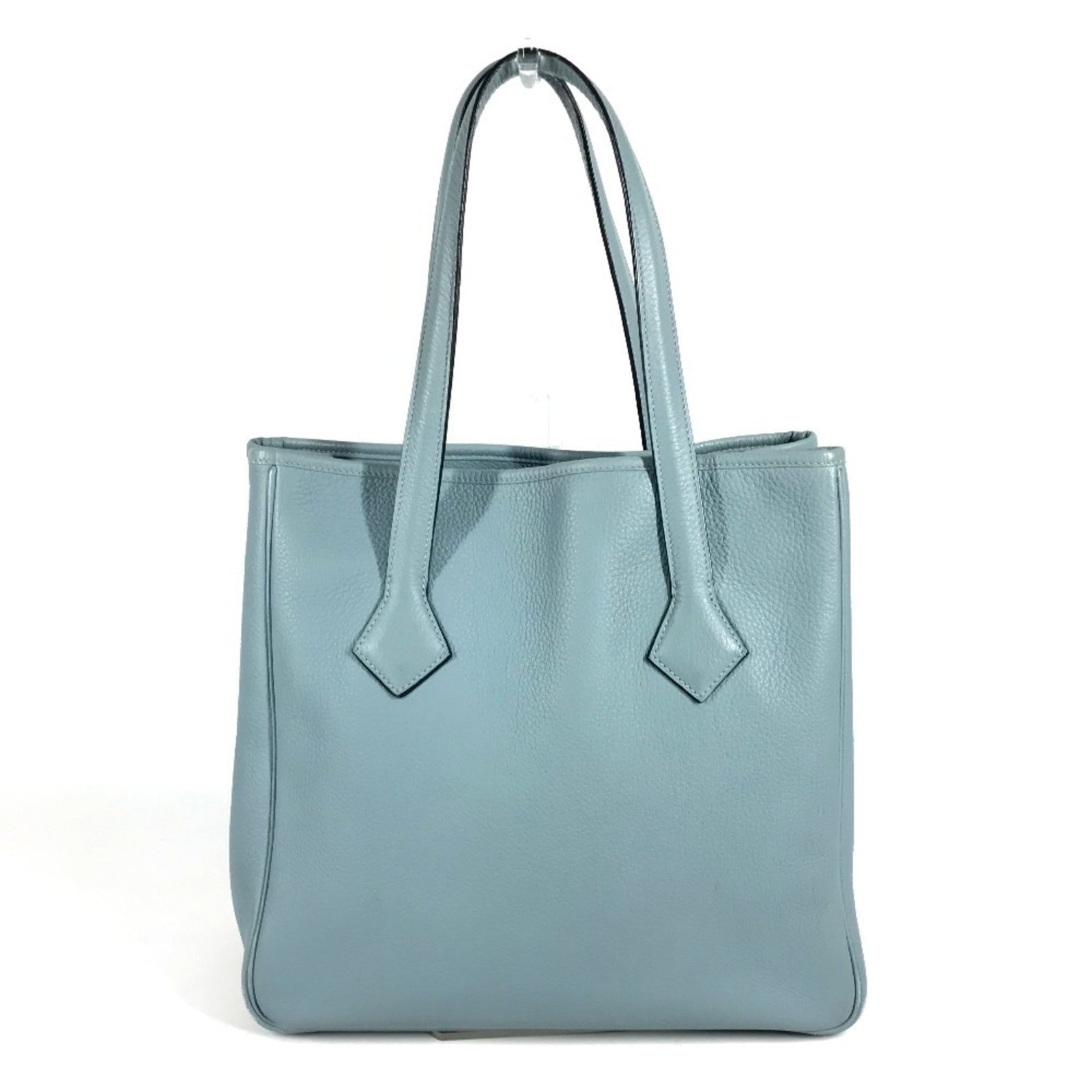 Clemence Tote Bag Hermes Leather Taurillon Shoulder Bag: Clemence Tote Bag Hermes Leather Taurillon Shoulder Bag Taurillon Clemence Leather Tote Bag from Hermes features a timeless design with a blue color. The bag's condition shows traces of usage, with