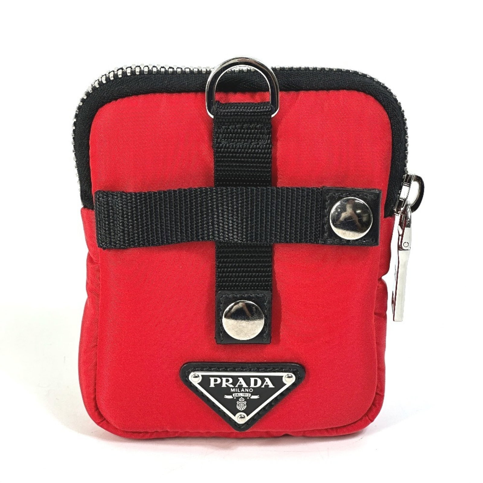 Nylon pouch by Prada: Nylon pouch by Prada Nylon pouch by Prada, made from durable nylon material and featuring a sleek black design with red accents. Measuring 13cm x 10.5cm, this compact pouch has been carefully