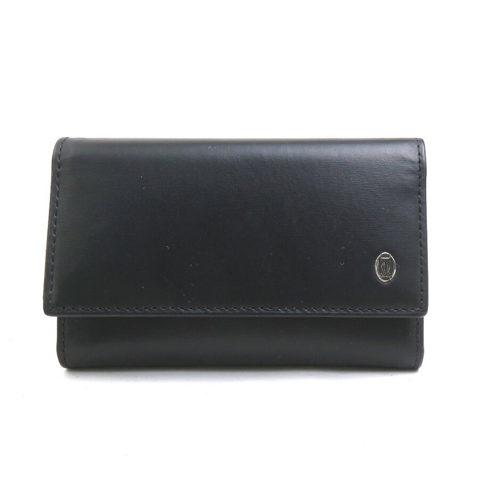 Cartier Keycase: Cartier Keycase Black Cartier Keycase with button closure, bearing traces of usage and minor scratches. This used keycase is in good condition, showing signs of wear but remaining intact. The classic