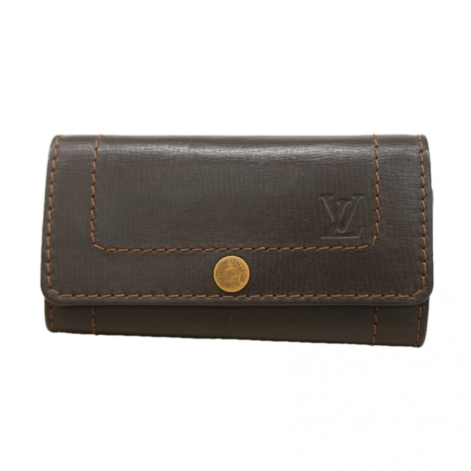 Keycase from Louis Vuitton: Keycase from Louis Vuitton Used Louis Vuitton Keycase in coffee color, with traces of usage visible and minor scratches/dirt present. The keycase bears a signature but details on the origin of the sig