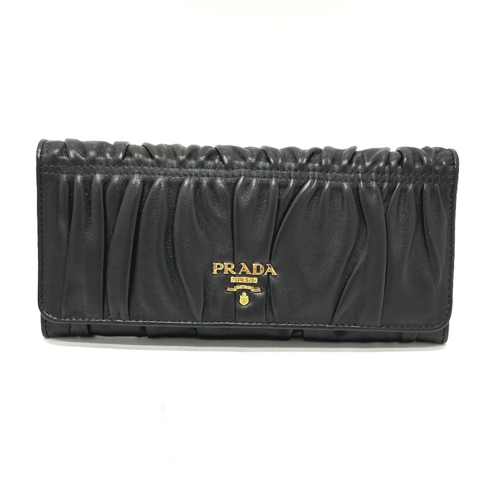 Prada Long Wallet (Bi-Fold) Leather: Prada Long Wallet (Bi-Fold) Leather Used Prada Long Wallet (Bi-Fold) Leather in black, featuring a classic bi-fold design with a durable leather exterior. The wallet has some minor scratches and dirt,