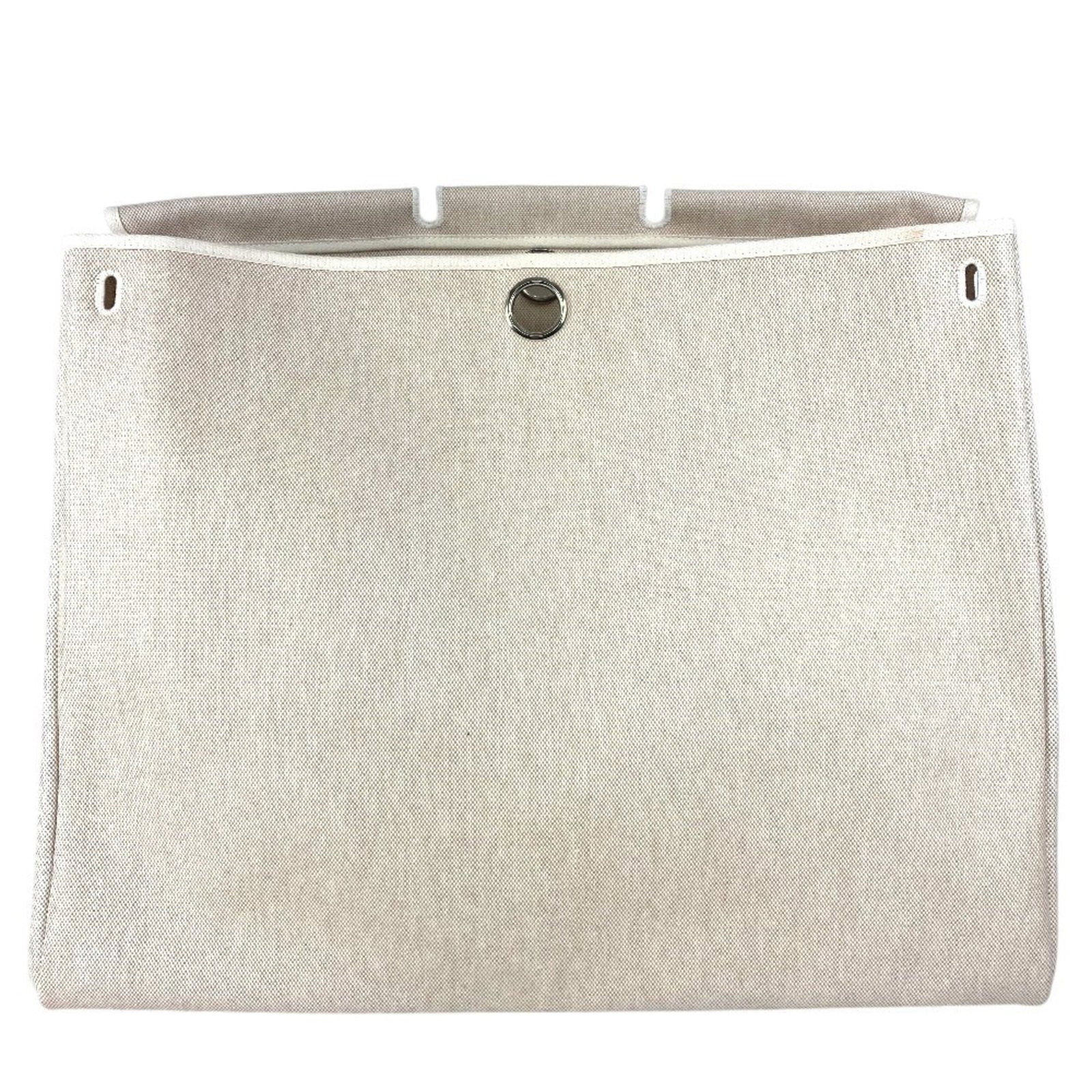 Handbag from Hermes: Handbag from Hermes This classic Hermes canvas handbag boasts a timeless beige color and a spacious interior, measuring 42cm x 50cm x 25cm. With its durable canvas material and signature style, it's a