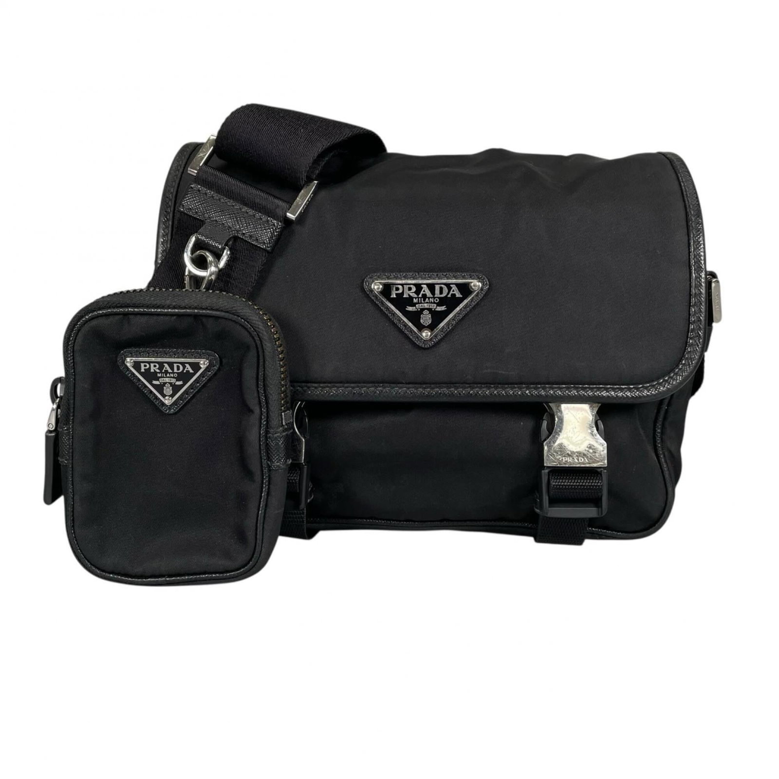 Shoulder Bag Nylon by Prada: Shoulder Bag Nylon by Prada Black Prada shoulder bag made from high-quality nylon, featuring silver hardware and a sleek design. The bag has visible signs of usage, including scratches and dirt, but r