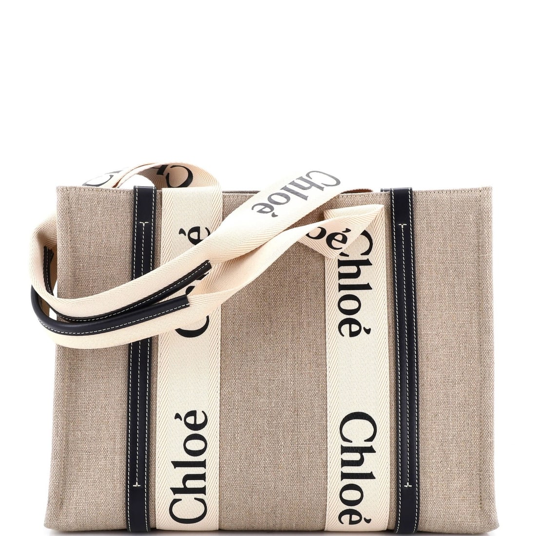 Canvas tote medium leather Chloe with Woody: Canvas tote medium leather Chloe with Woody Canvas tote with medium leather strap, featuring the iconic Woody design from Chloe. This neutral-colored bag boasts a sturdy canvas exterior and comfortabl