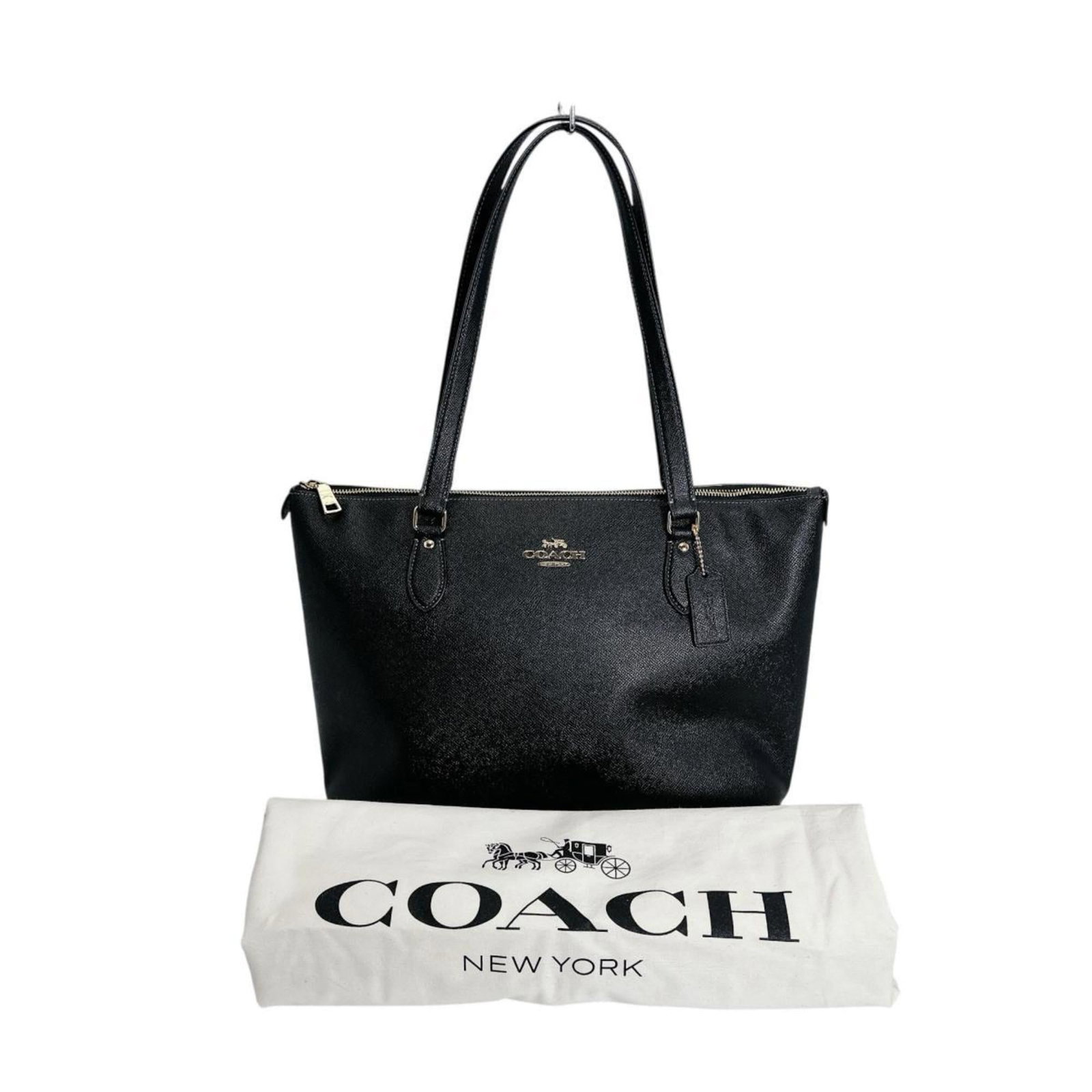 Leather tote by Coach: Leather tote by Coach This Coach leather tote bag boasts sleek black leather and a compact size, measuring 25cm x 37cm x 15cm. With its durable construction, it remains in excellent condition,