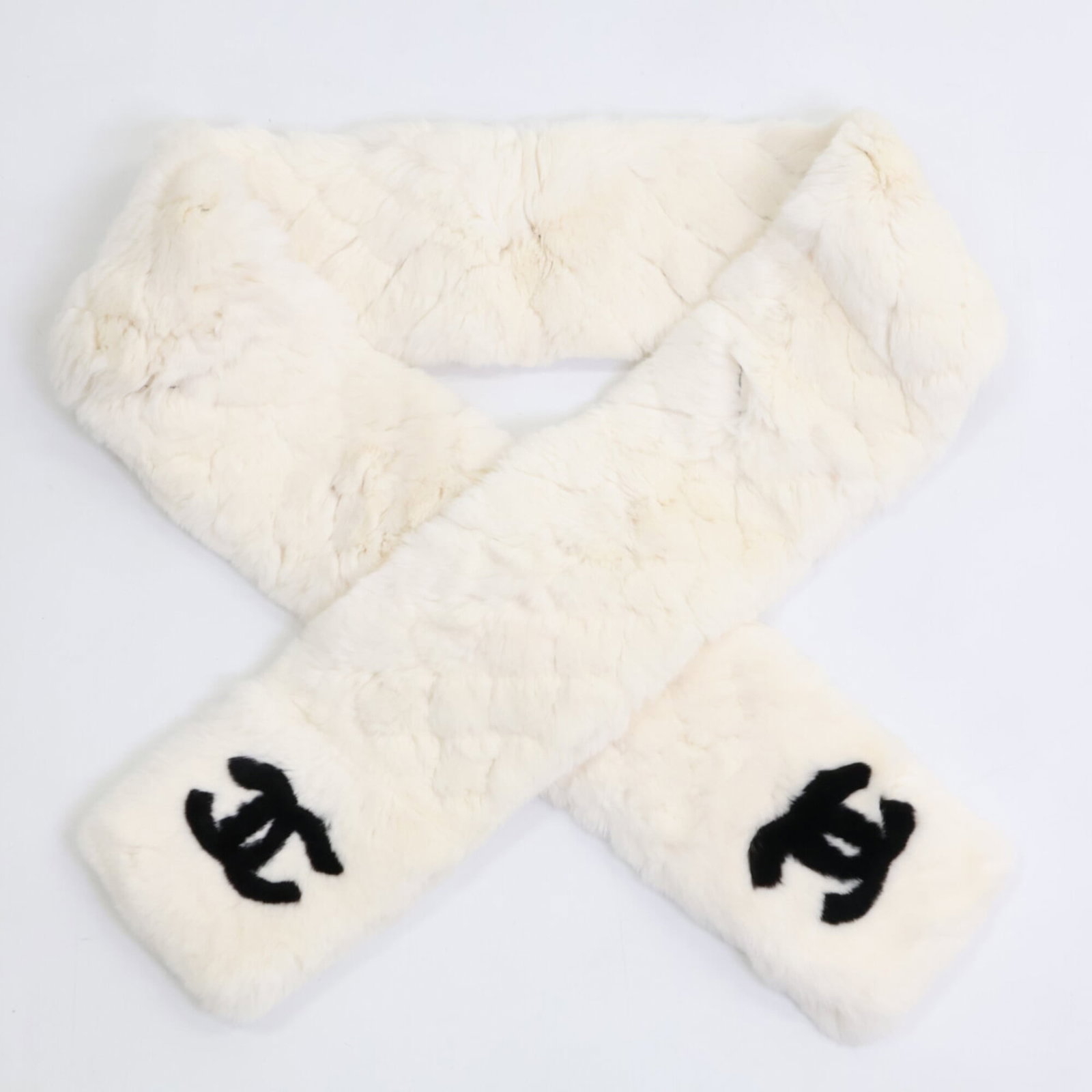 Fur Stole by Chanel: Fur Stole by Chanel White rabbit fur stole by Chanel, measuring 1.42m x 12cm in size, features high-quality materials and a mint condition like new state. This used item boasts a luxurious feel and