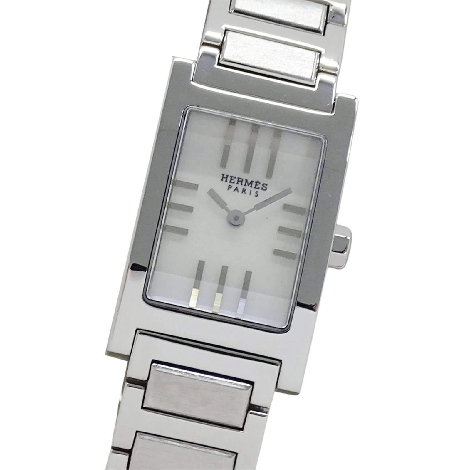 Wristwatch by Hermes: Wristwatch by Hermes Stainless steel case and band add an edgy touch to this white dial wristwatch from Hermes, with a diameter of 19mm. The watch has been well-worn, showing traces of usage and