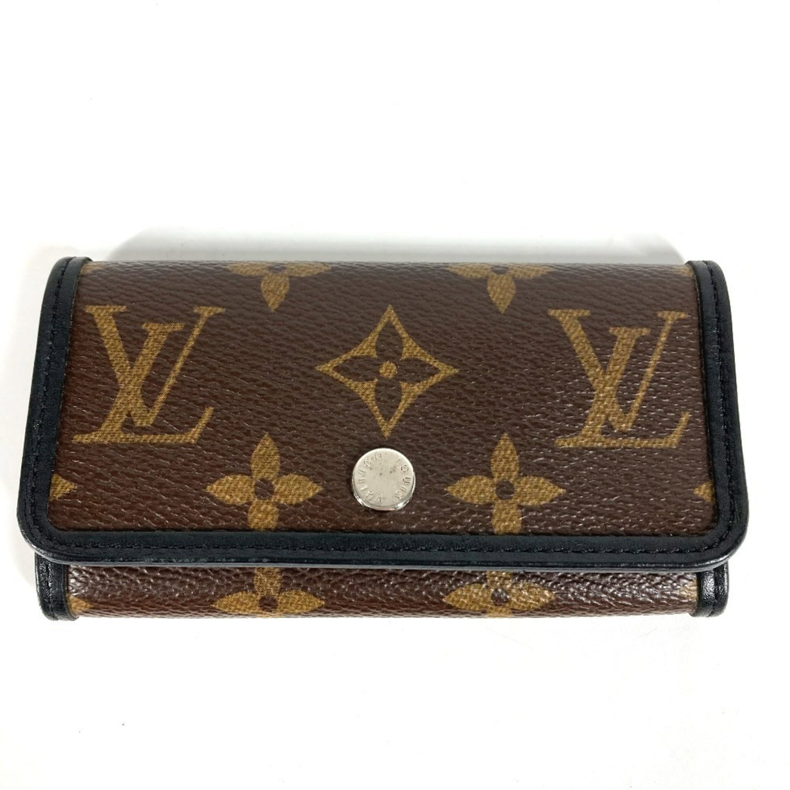 Monogram Keycase Louis Vuitton: Monogram Keycase Louis Vuitton Monogram Macassar Louis Vuitton Keycase in Black and Brown, featuring the iconic monogram pattern. This used keycase has six key hooks and a classic design that