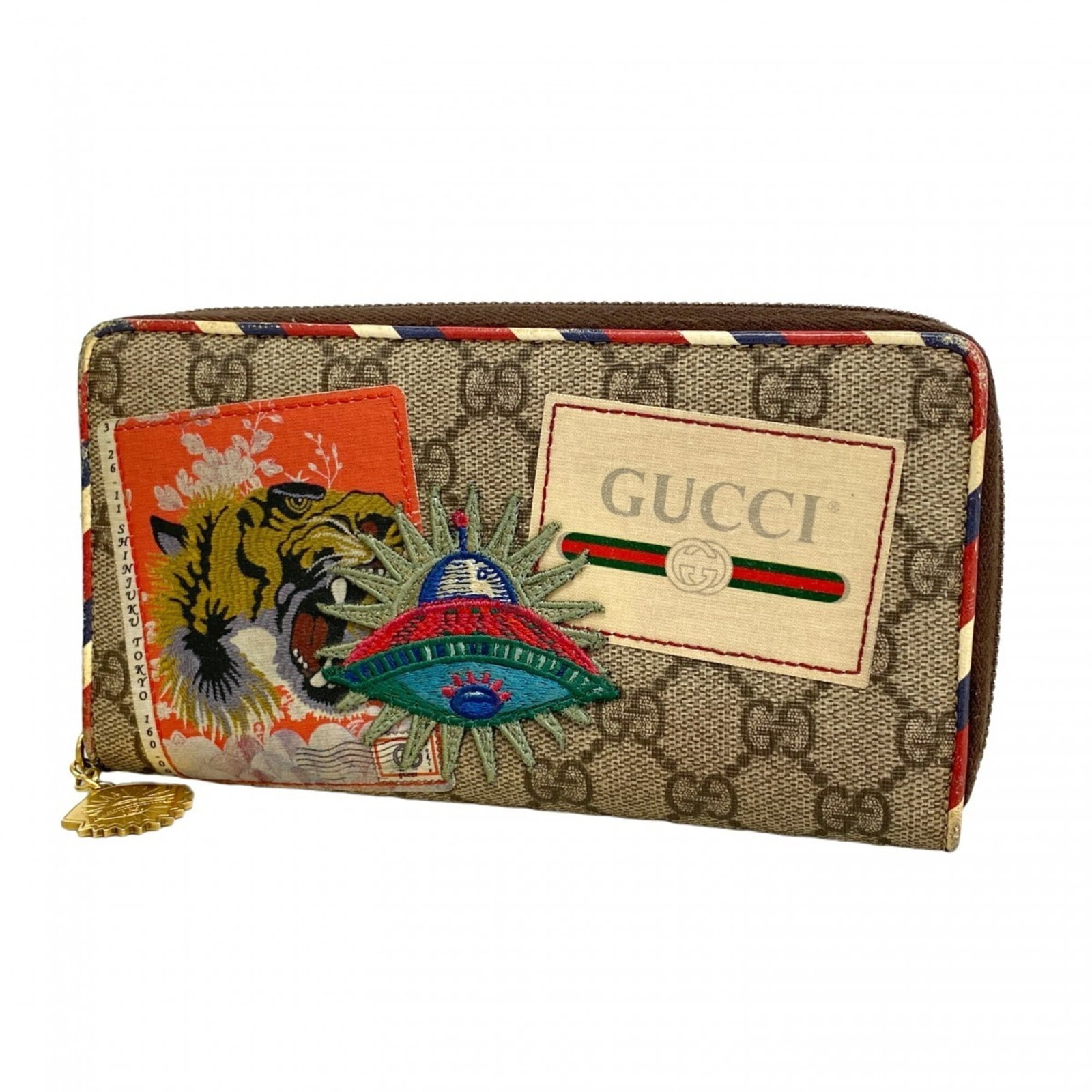 PVC Bi Fold Wallet By Gucci: PVC Bi Fold Wallet By Gucci Gucci's PVC bi-fold wallet boasts a sleek, brown design with a durable construction. Measuring 10cm x 18.5cm x 3cm, it offers ample space for cards and cash. With its