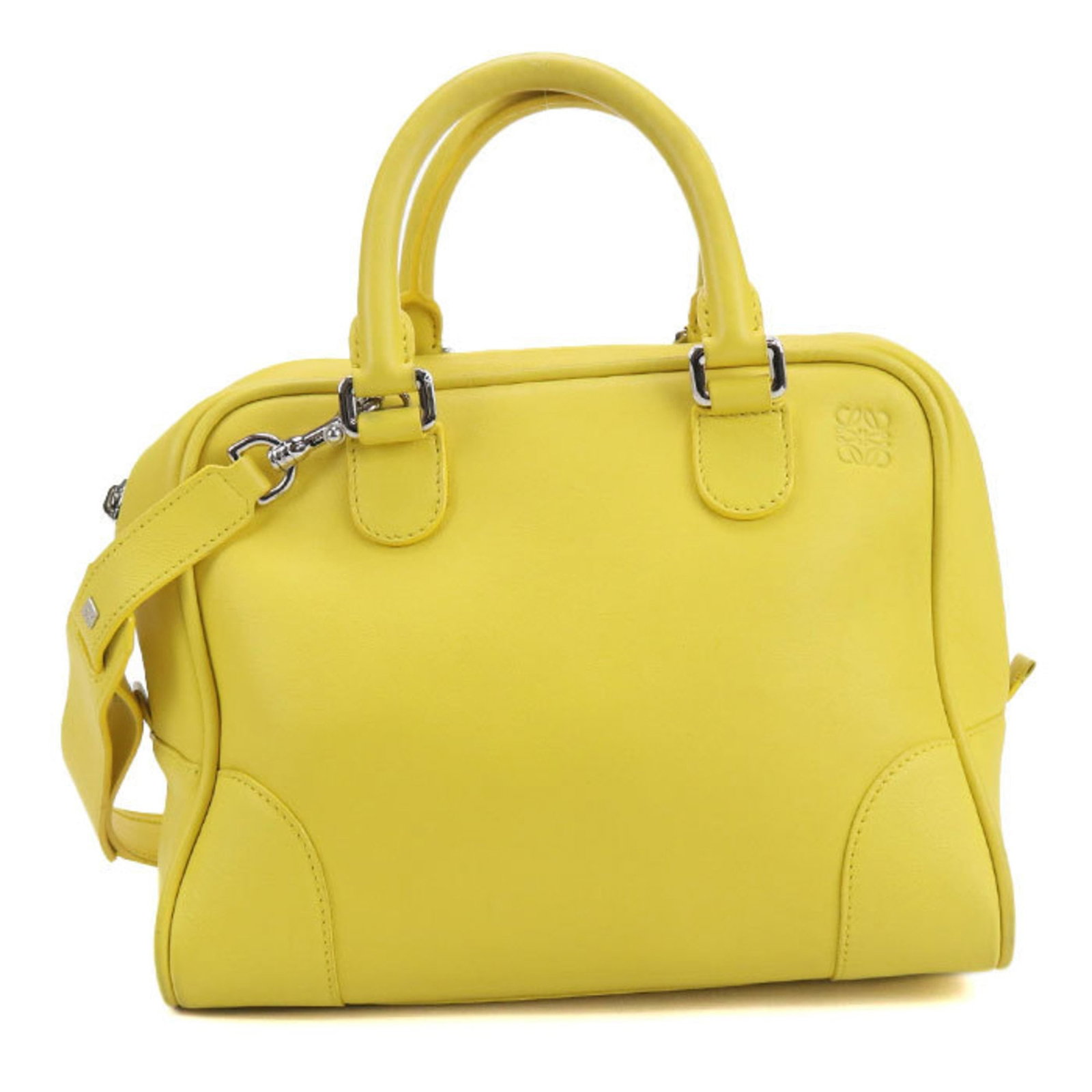 Handbag Leather from Loewe: Handbag Leather from Loewe This vintage Loewe handbag boasts a striking yellow leather exterior, adorned with sleek silver hardware. Measuring 22cm x 27cm x 16cm, it features calfskin material and a c