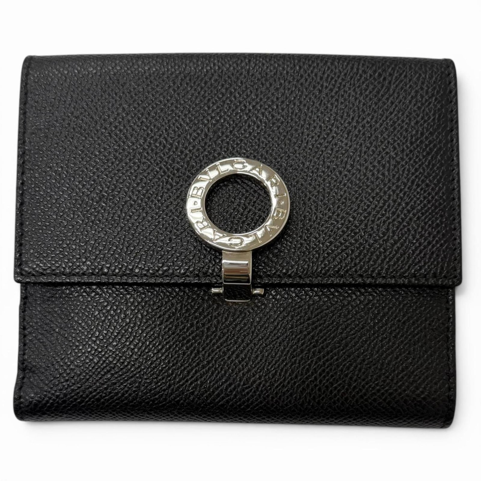 Bvlgari Wallet (Bi-Fold) Leather: Bvlgari Wallet (Bi-Fold) Leather Bvlgari's sleek bi-fold leather wallet boasts a sophisticated black finish, complemented by subtle silver accents. Measuring 11.5cm x 12.2cm, it features a classic