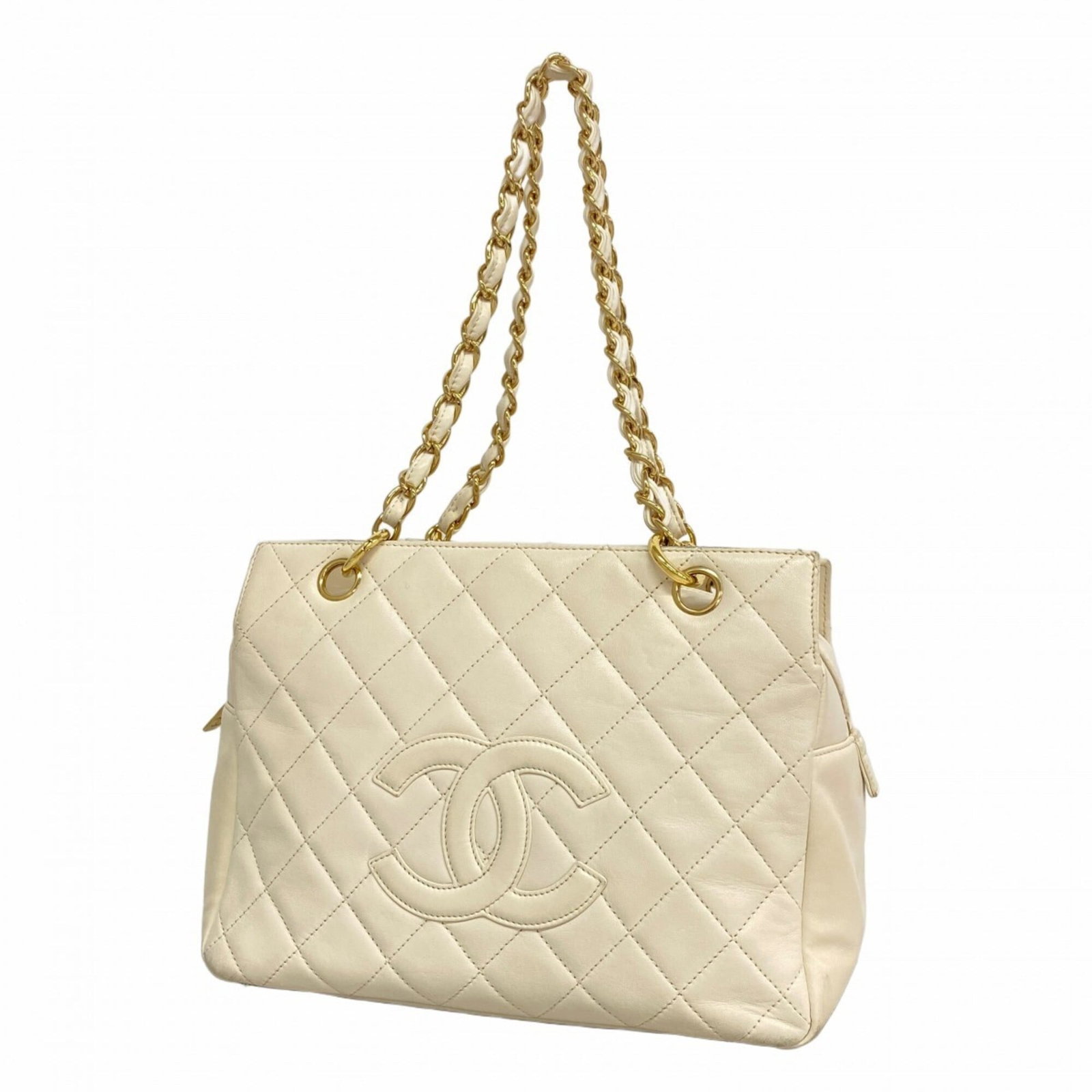Tote Bag Leather from Chanel: Tote Bag Leather from Chanel Chanel's iconic tote bag features luxurious lambskin leather in ivory, complemented by champagne gold hardware. The classic design showcases the brand's signature style wi
